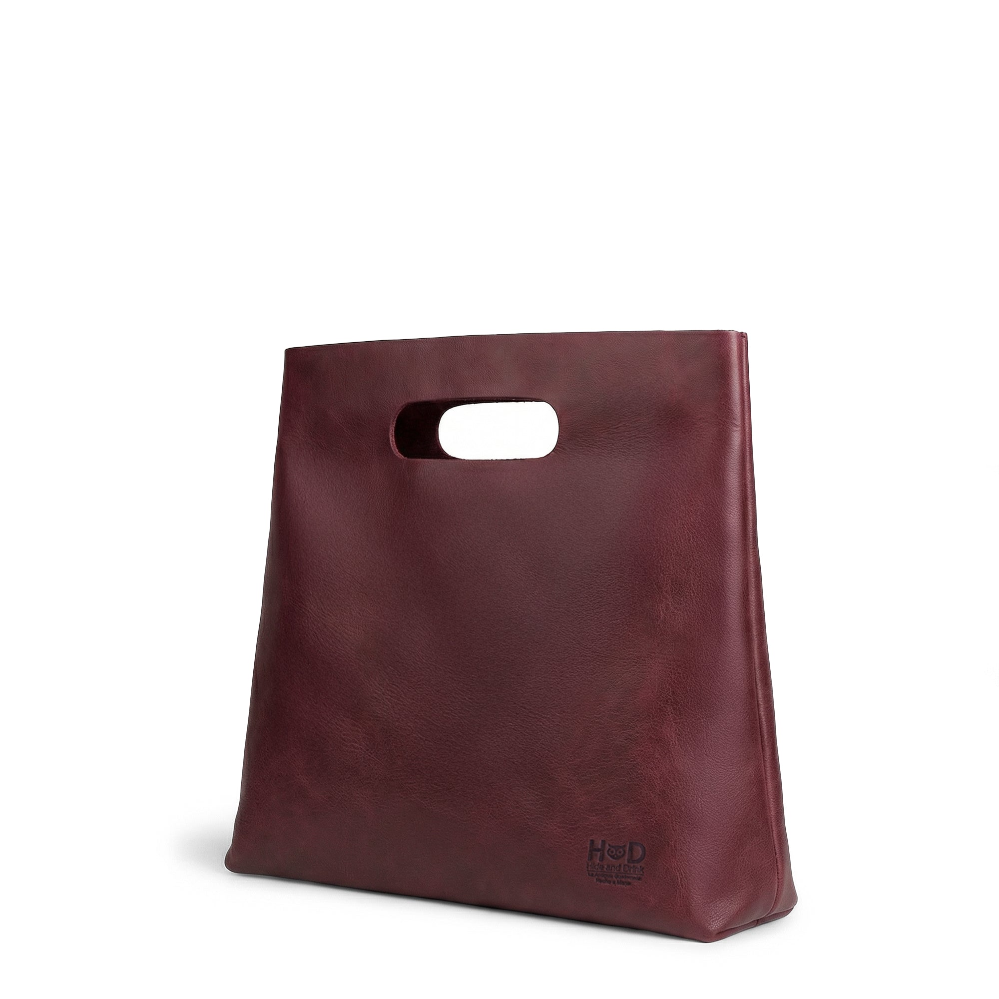 The side profile of the red Minimalist Boho Handbag by Hide & Drink, showcasing its unique design and structure. This Minimalist Handbag for Women functions as a chic Tote Bag, made from beautiful Full Grain Leather, reflecting StockyardX‚Äôs artisan dedication to Small Batch Production, with each piece Handmade in La Antigua Guatemala & Oaxaca Mexico.