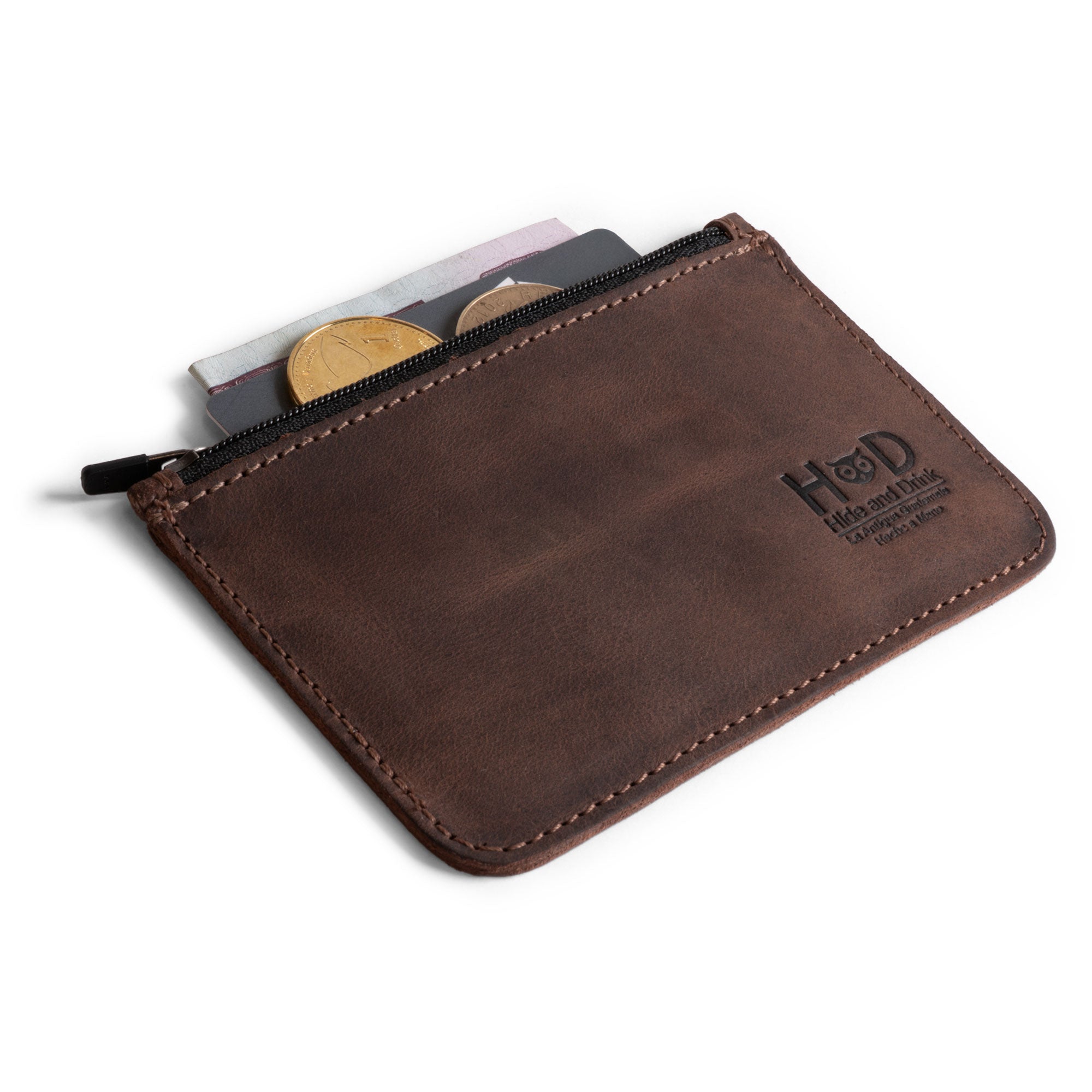 Hide & Drink Zippered Wallet showcasing a smooth Full Grain Leather finish, perfect for organizing cards and coins. Ideal as a card case, folded bills storage, and travel accessory, this wallet is hand cut and hand sewn, embodying artisan craftsmanship from La Antigua Guatemala & Oaxaca Mexico.