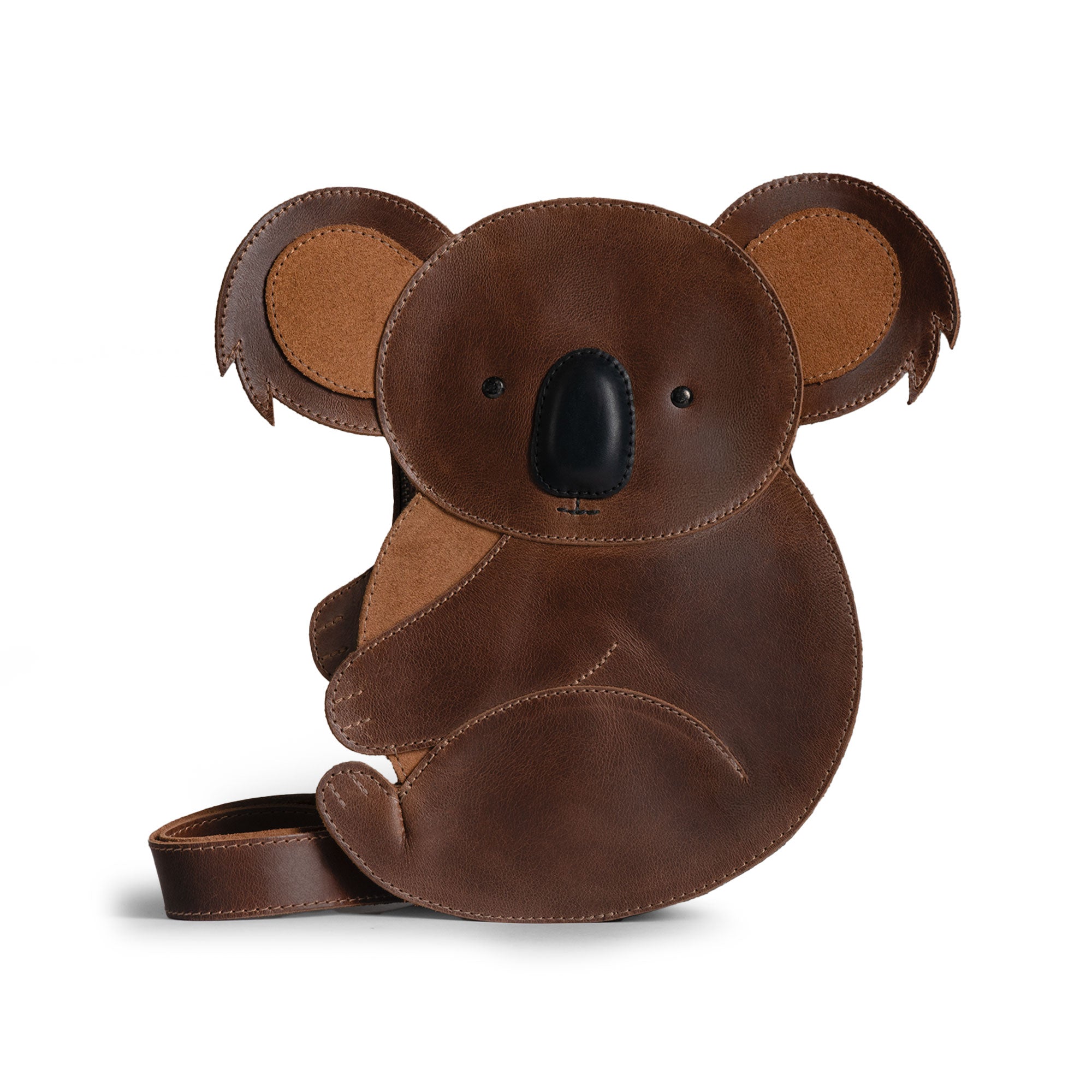 Tudi Frudi Leather Koala Crossbody Bag showcasing a whimsical koala design made of full grain leather. This versatile bag features an adjustable shoulder strap and is handmade in La Antigua Guatemala and Oaxaca Mexico. Perfectly crafted for daily use as a messenger bag, travel backpack, or versatile purse for men and women.
