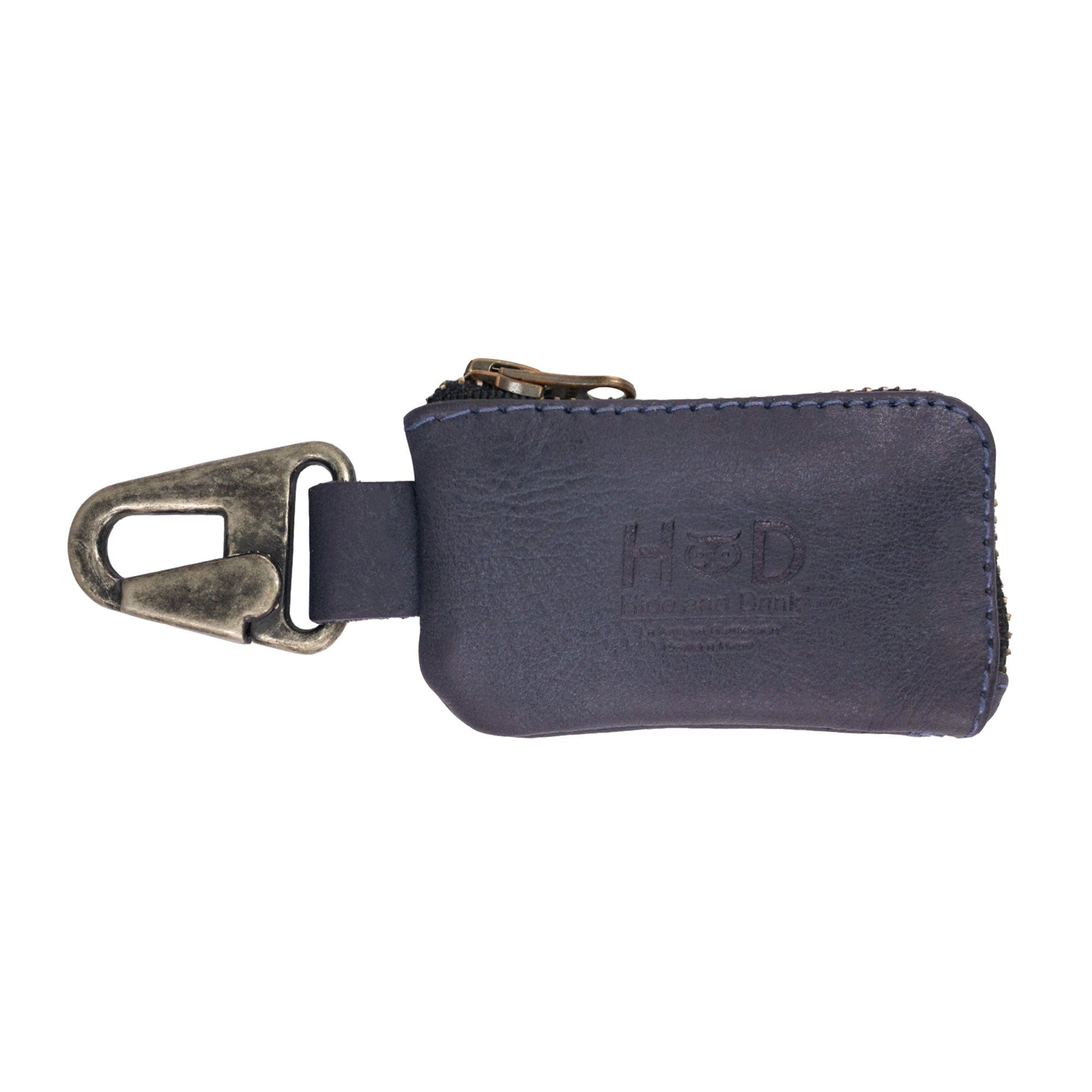 A detailed shot of the Car Key Holder by Hide & Drink featuring its rustic charm in full grain leather. This useful accessory holds cash, keys, and can organize headphone cables and flash drives, made with care in La Antigua Guatemala & Oaxaca Mexico.