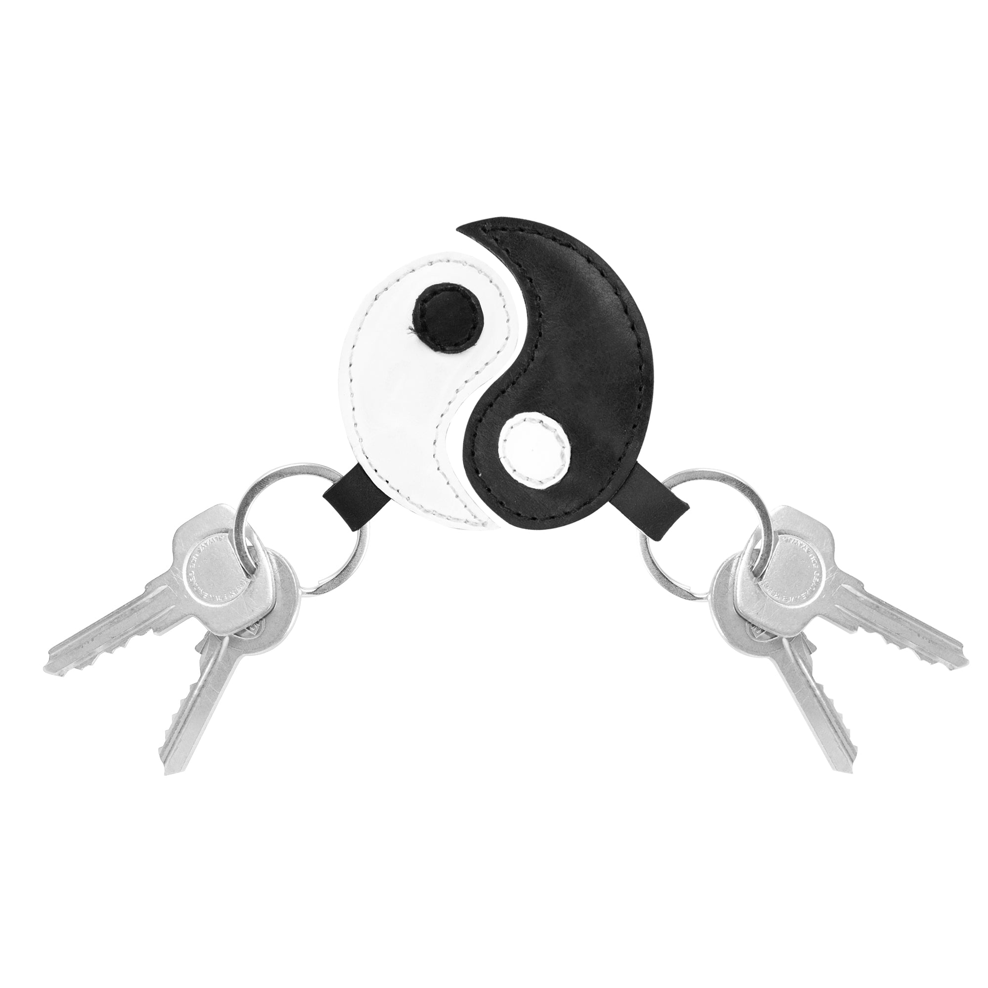 A stylish Yin Yang Keychain (2 pieces) by Hide & Drink featuring two interlinked key rings, symbolizing harmony and balance. This full grain leather accessory represents Chinese culture and friendship, perfect for those who appreciate artisan craftsmanship. Experience small batch production with hand-cut, hand-sewn details in each piece, fire branded for quality. Handmade in La Antigua Guatemala & Oaxaca Mexico.