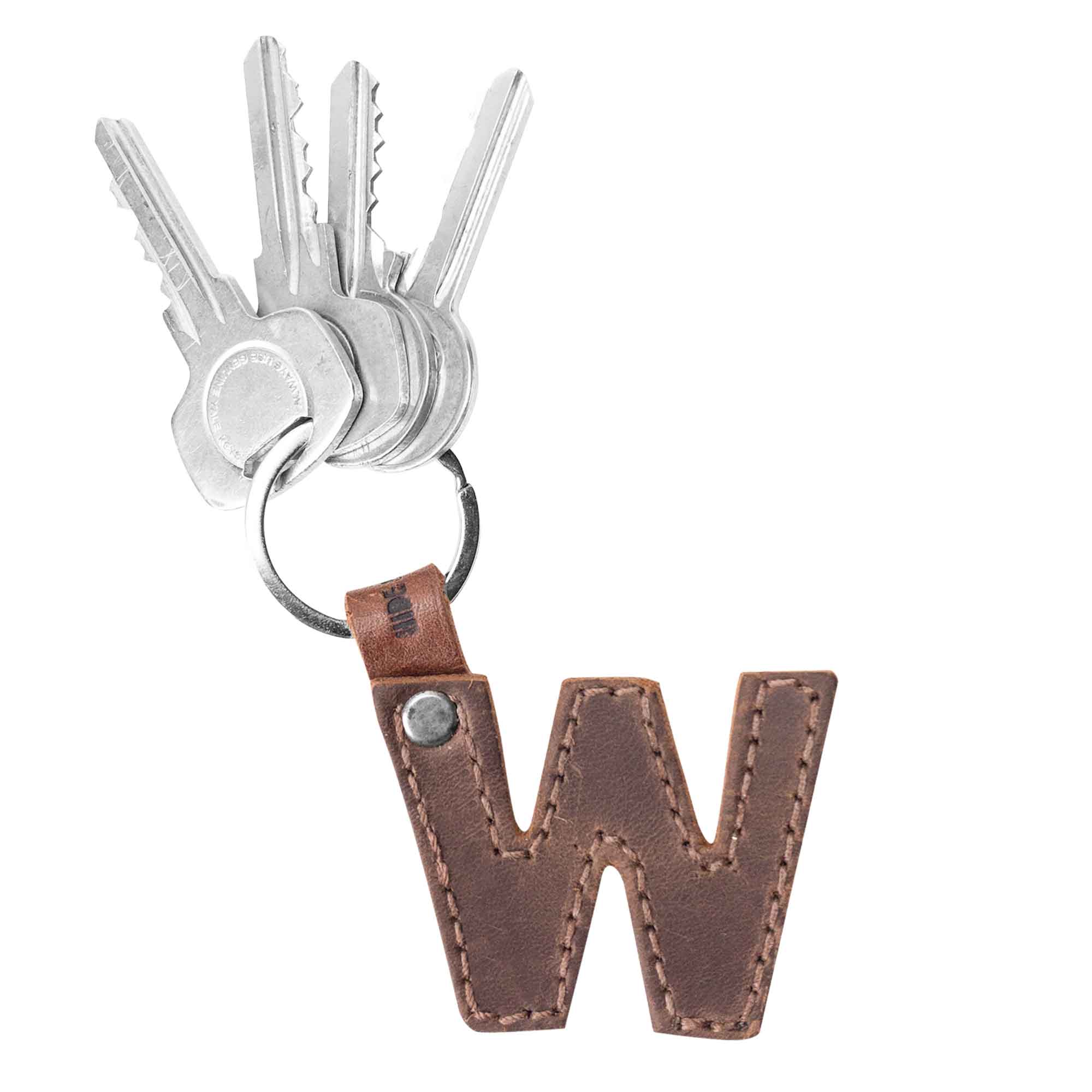 Letter W displayed in thick leather Alphabet Letter Keychain by Hide & Drink. This exceptional piece crafted from Full Grain Leather highlights artisan workmanship through small batch production from La Antigua Guatemala.