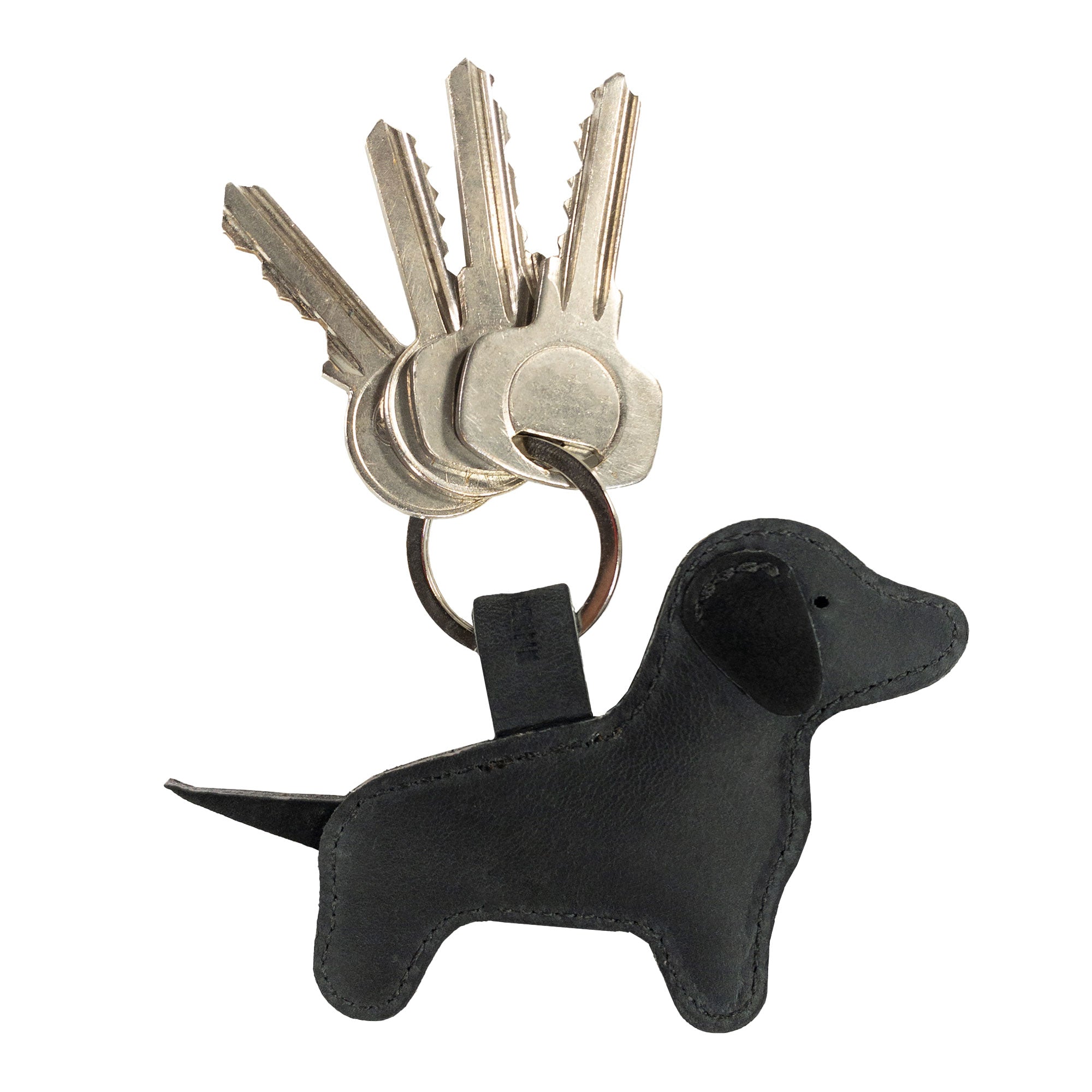 The Hide & Drink Dog Keychain, depicted here in a sleek black Full Grain Leather, offers a modern twist on the cute dog-shaped design. This handmade keyring reflects small batch production and artisan quality, made with care in La Antigua Guatemala & Oaxaca Mexico.