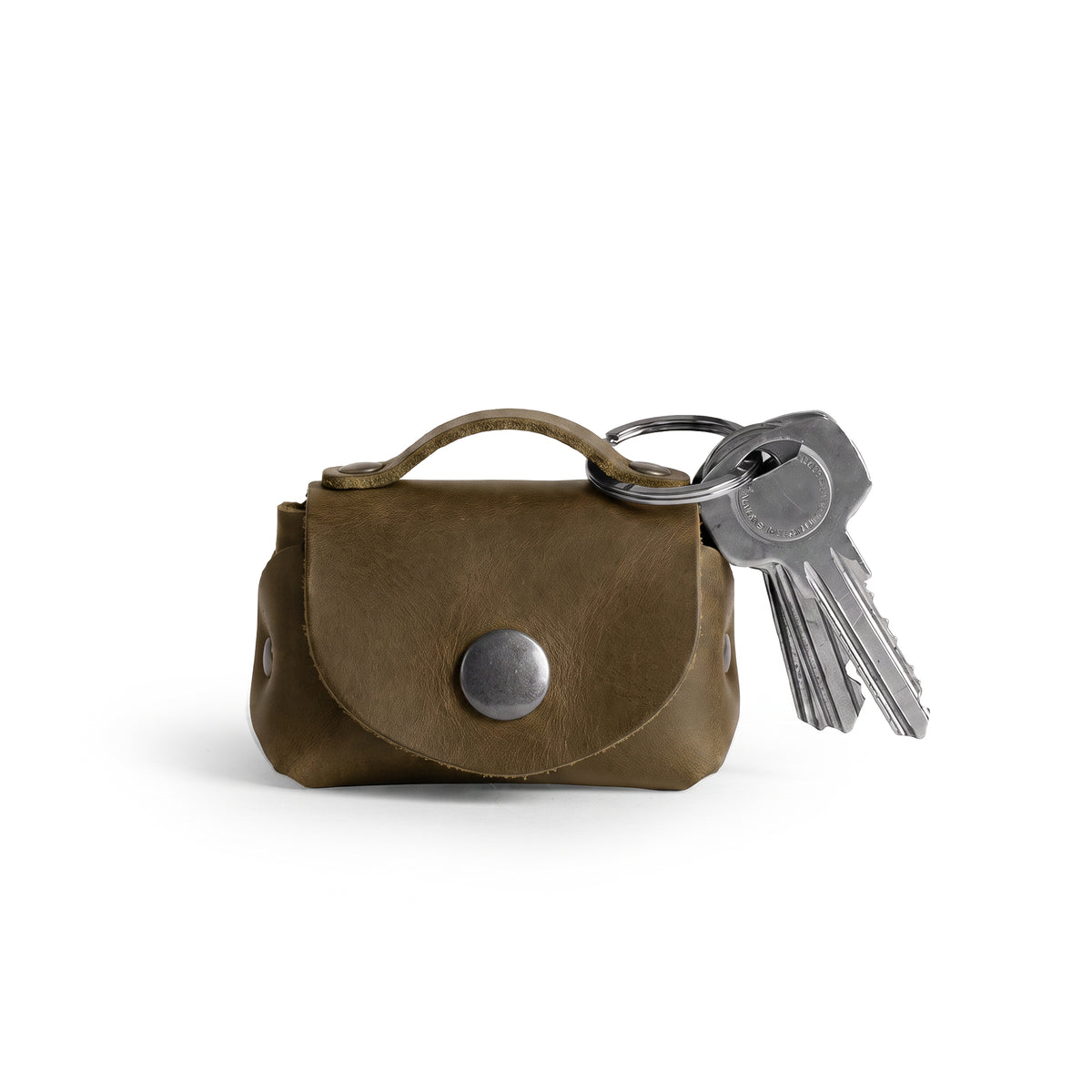 Tiny Handbag Keychain by Hide & Drink, showcasing a stylish Tiny Handbag with Key Ring Holder made from Full Grain Leather. This artisan piece represents Small Batch Production, and is Hand Cut, Hand Sewn, and Fire Branded. It is proudly Handmade in La Antigua Guatemala & Oaxaca Mexico.