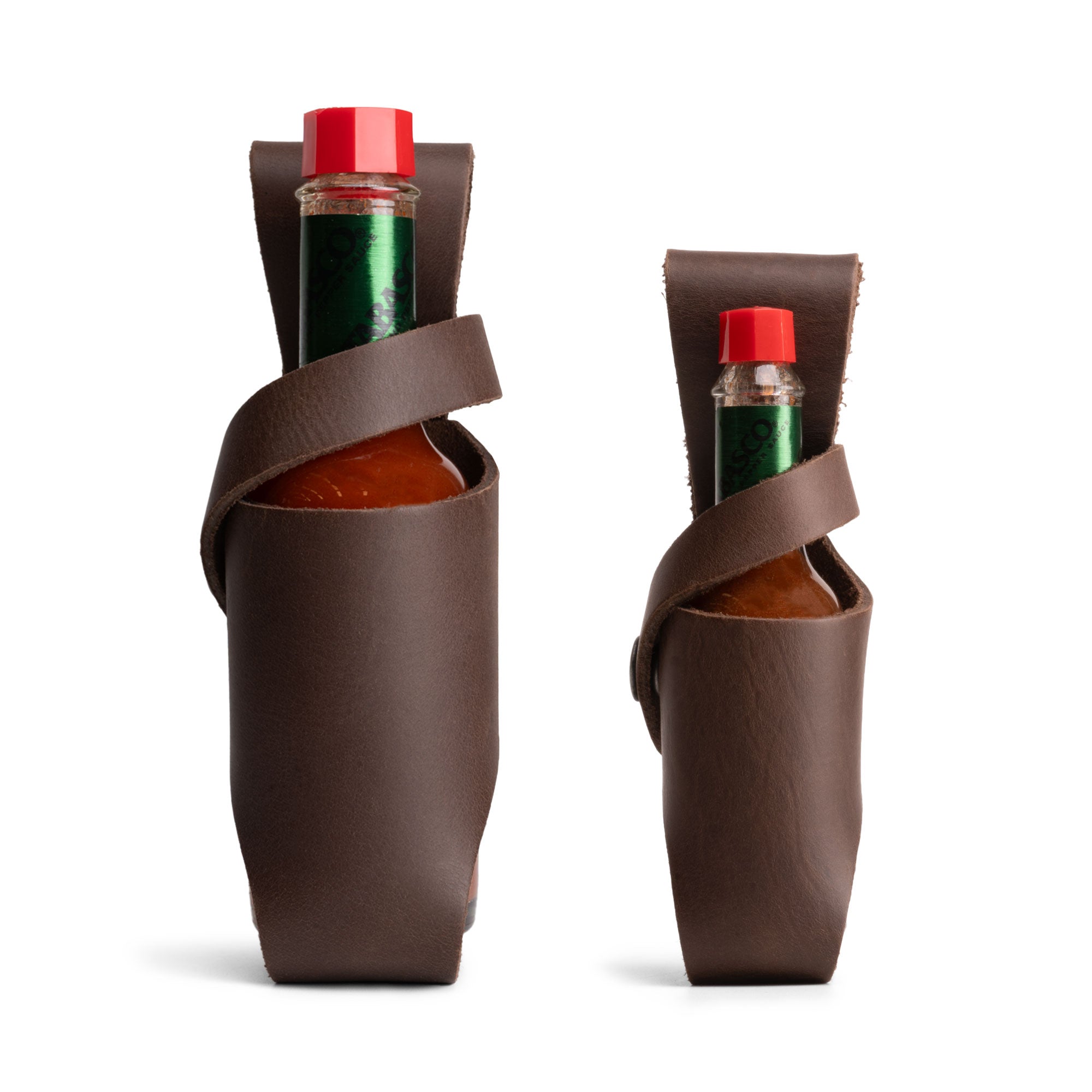 Hide & Drink Tabasco Holsters (2pk) featuring a set of 2 hot sauce holsters for 5oz and 2oz bottles. These leather bottle holders are compatible with Tabasco, Cholulah, and Sriracha hot sauce. Made from full grain leather, each holster showcases small batch production, artisan craftsmanship, and is handmade in La Antigua Guatemala & Oaxaca Mexico.