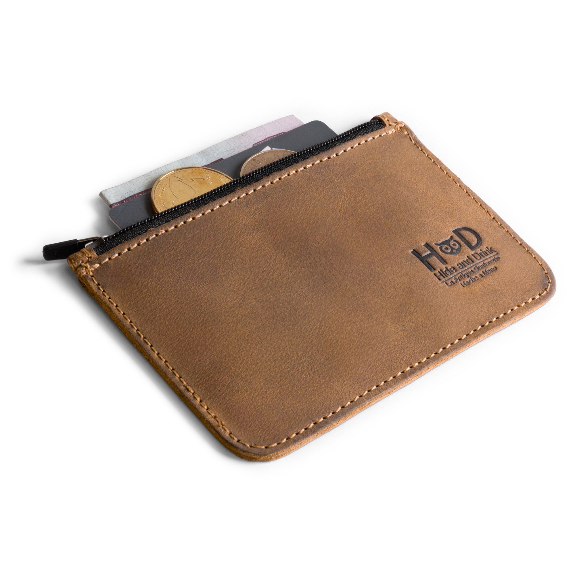Hide & Drink Zippered Wallet packed with coins, bills, and cards, demonstrating its utility as a travel accessory and coin organizer. Crafted from full grain leather, this wallet reflects the small batch production quality and artisan skill.