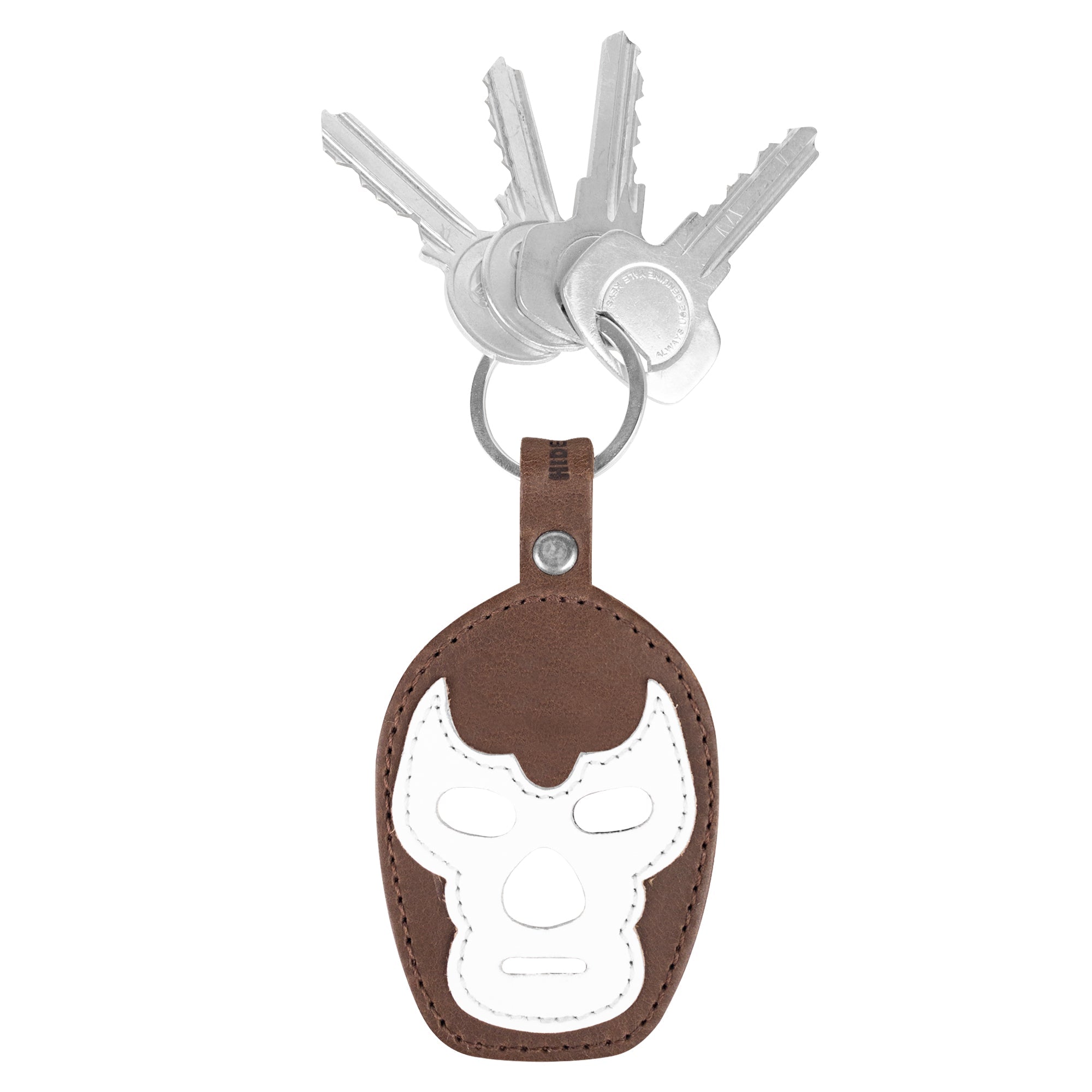 An elegant view of the Luchador Mask Leather Keychain, showcasing its craftsmanship and design. This keyring from Hide & Drink functions as a key organizer and is made from durable full grain leather, celebrating the art of small batch production, hand cut and hand sewn in La Antigua Guatemala and Oaxaca Mexico.