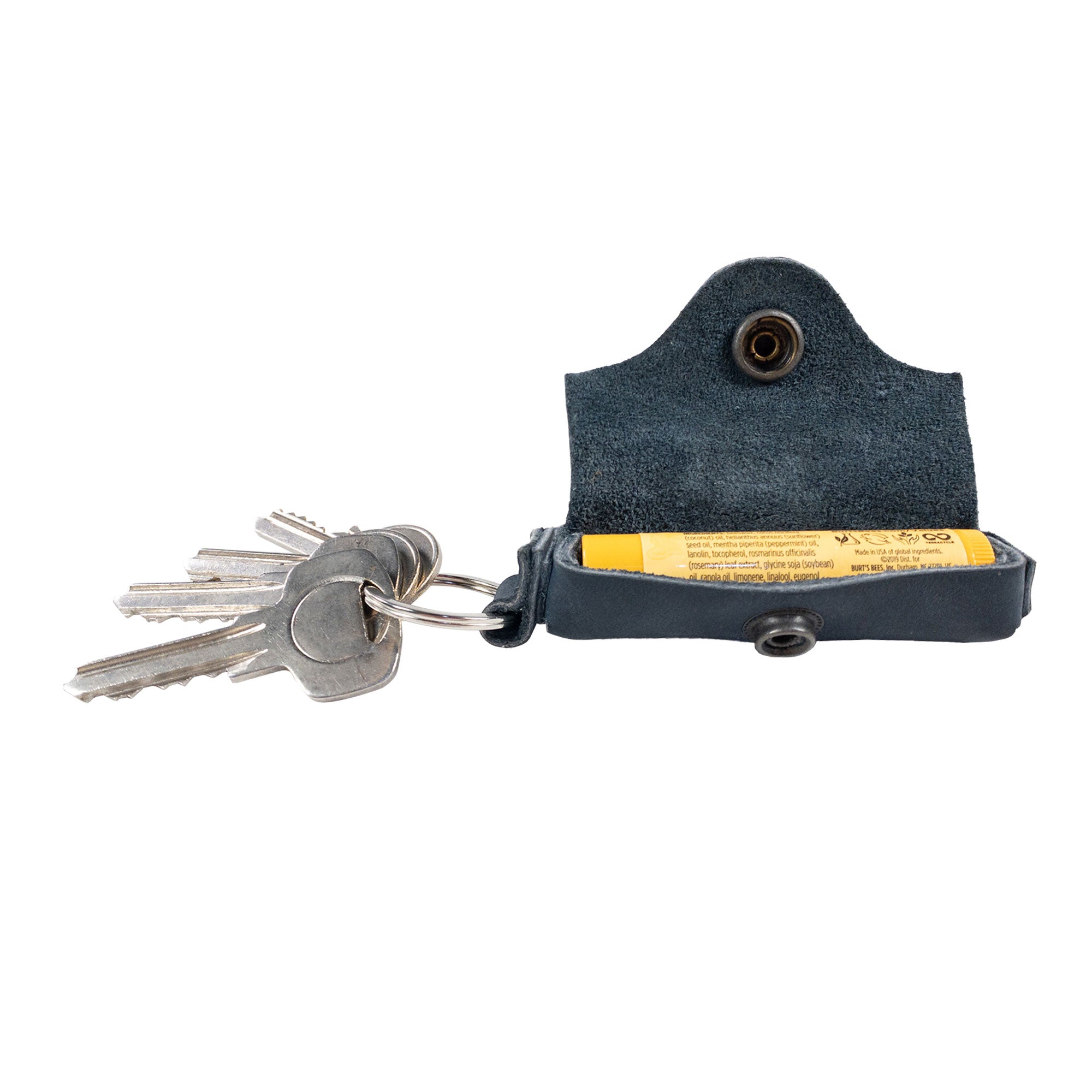 Side view of the Hide & Drink Lip Balm Key Chain with keys attached, demonstrating its functionality as a lip balm keychain holder. Crafted from full grain leather, it elegantly combines style with lip protection.