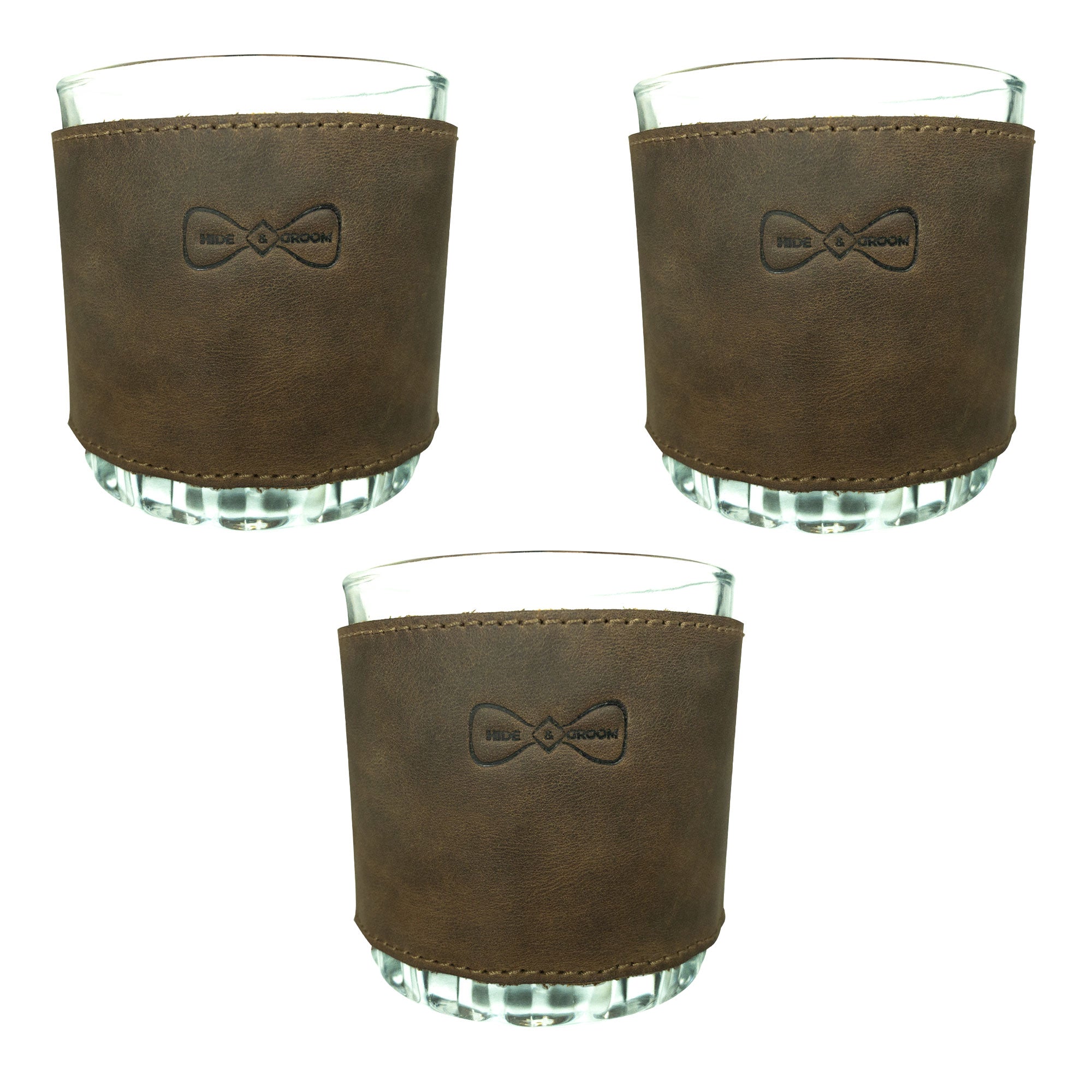 Set of 3 Drinking Glass Covers for Groomsmen by Hide & Groom, ideal for wedding ceremonies and dinner parties, made of full grain leather. These artisan covers are perfect for groomsmen, best men, and bachelors. Each piece reflects small batch production, hand cut, hand sewn craftsmanship, and is fire branded, handcrafted in La Antigua Guatemala & Oaxaca Mexico.