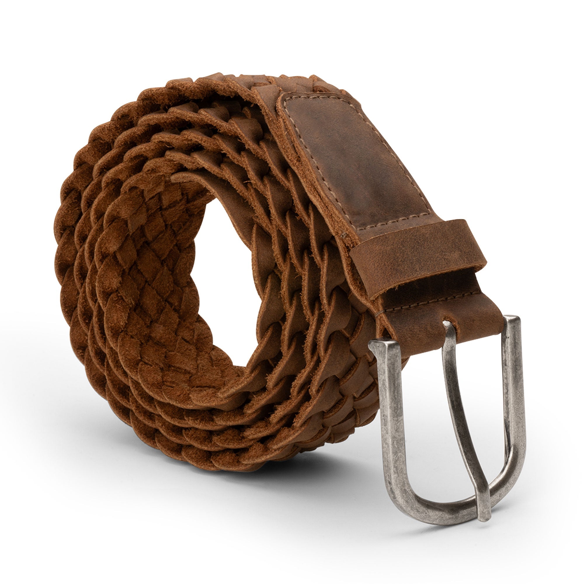 A detailed view of the Single-Piece Braided Belt by Hide & Drink, showcasing its craft with a braided design in full grain leather. This rugged yet stylish casual accessory exemplifies small batch production and handmade quality from La Antigua Guatemala & Oaxaca Mexico. Ideal for men's fashion, this belt is hand cut, hand sewn, and fire branded, perfect for adding a unique touch to any outfit.