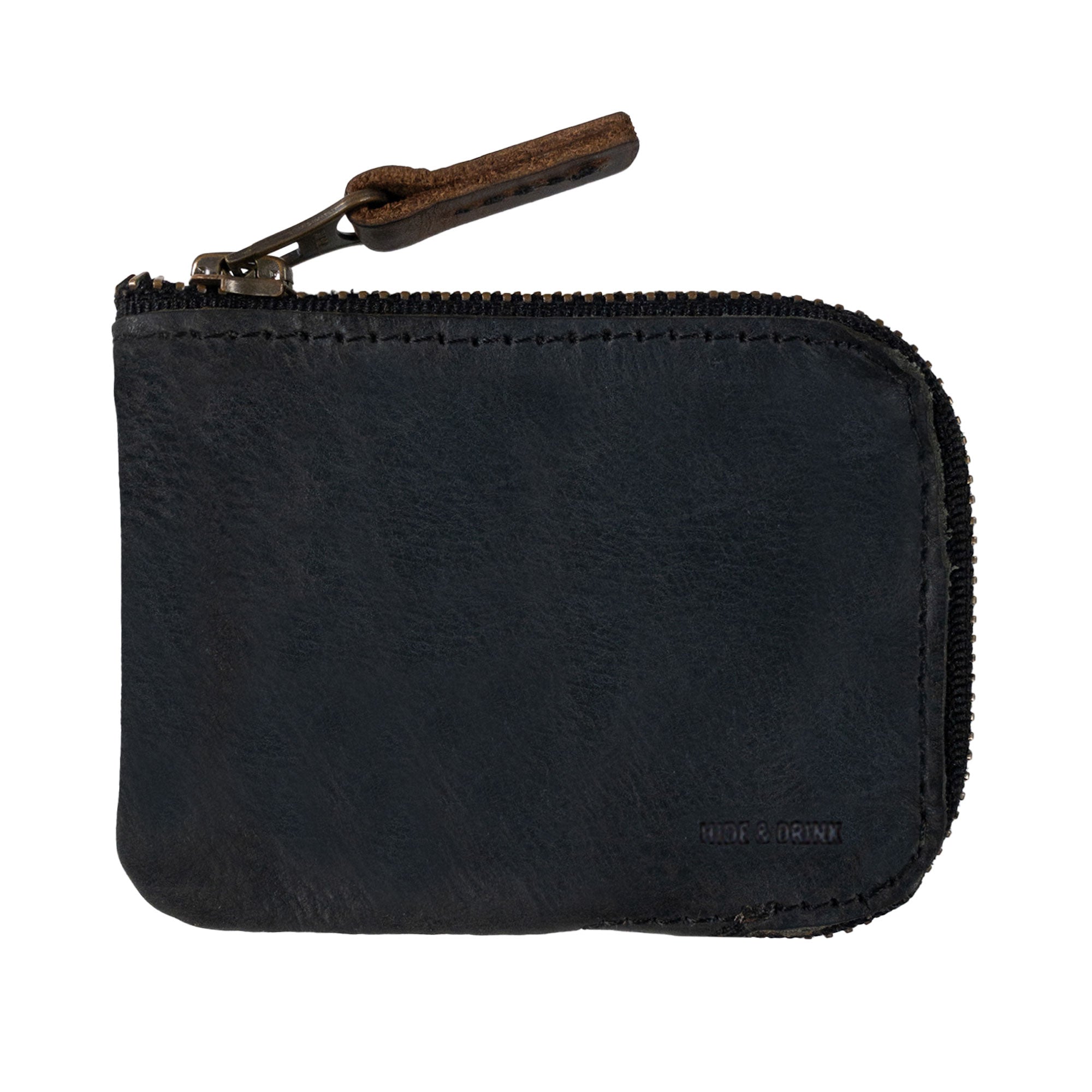 A close-up of a black Hide & Drink Card Pocket Wallet showing its quality craftsmanship. This zippered card wallet for men and women is an excellent coin pouch and money holder, artisan made from full grain leather in La Antigua Guatemala, emphasizing fire branded details.