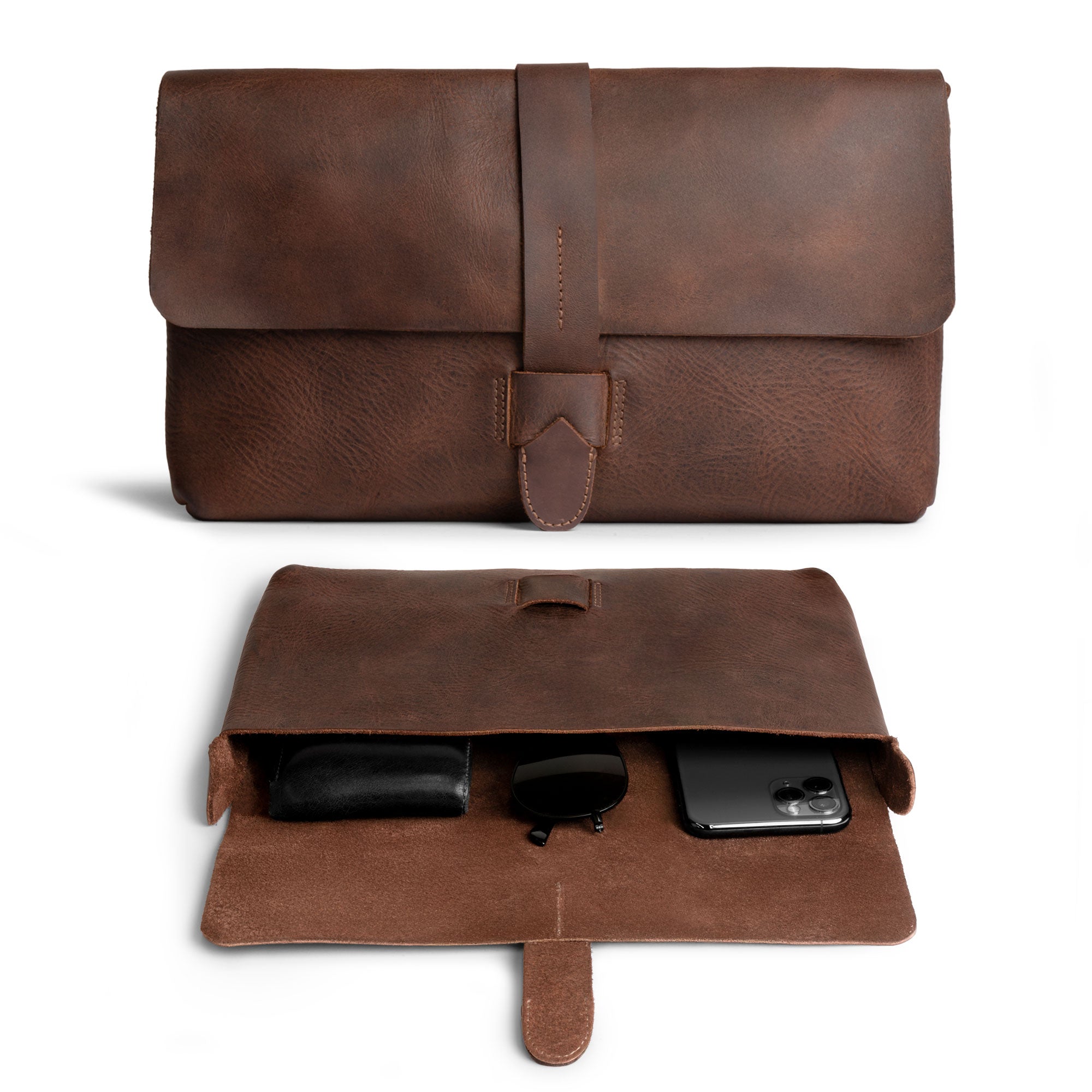 Hide & Drink Snapless Clutch Bag showcasing a rustic full grain leather design, perfect for organizing accessories like phones and sunglasses. This elegant clutch bag is part of small batch production that is hand cut and hand sewn by artisans in La Antigua Guatemala. Ideal as a case for your essentials and a stylish accessory.