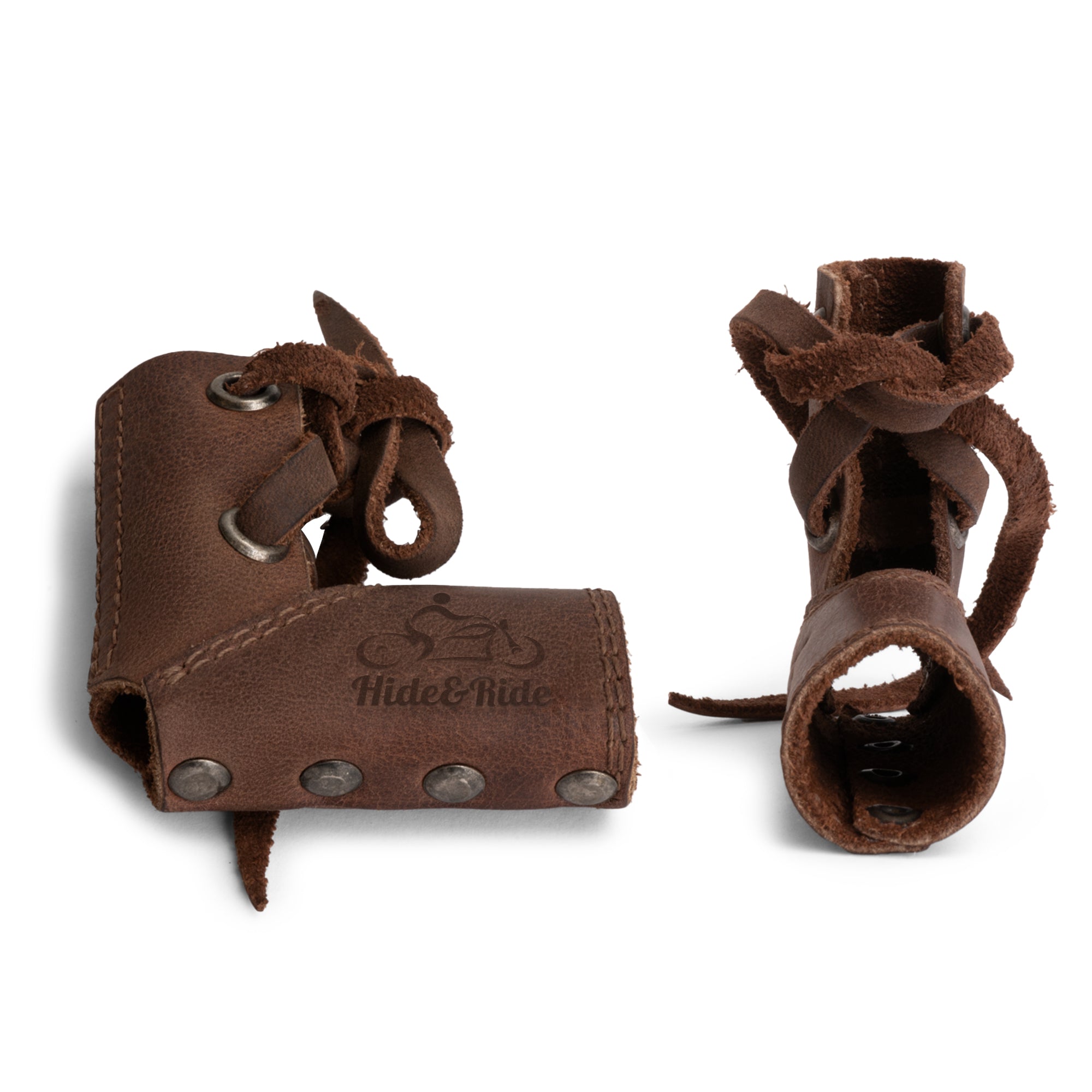 Two Hide & Ride Shift Lever Socks stacked showing their design in rich brown full grain leather. This set of 2 shifter shoe protectors is ideal for motorbike lovers, ensuring footwear safety while riding and showcasing handmade artistry from La Antigua Guatemala.