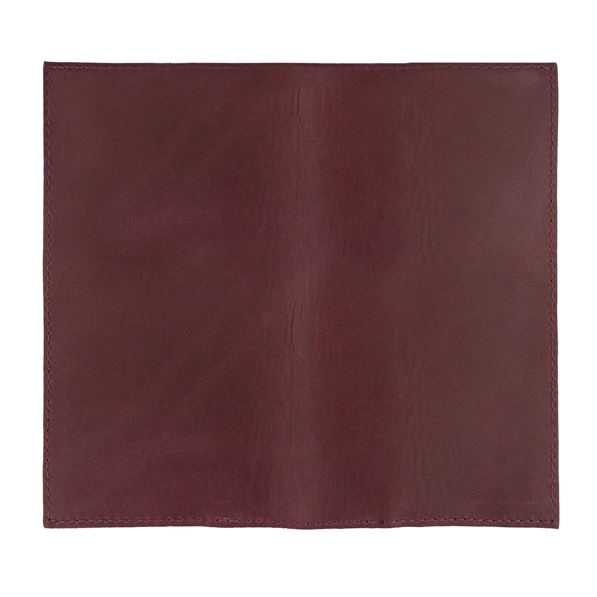 Daylight view of the Checkbook Leather Cover by Hide & Drink, featuring functionality as a minimalist organizer for standard checkbooks. This handmade item, created from full grain leather, exemplifies artisan craftsmanship from La Antigua Guatemala and Oaxaca Mexico, showcasing small batch production.