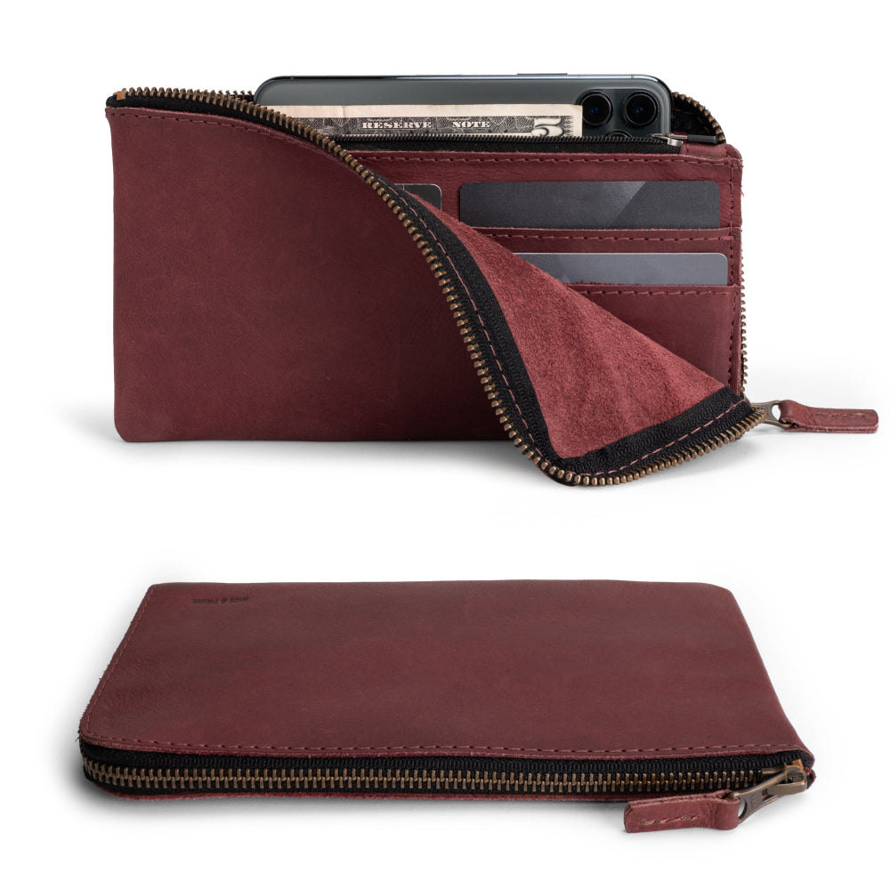 Front view of the Large Zippered Wallet by Hide & Drink in Sangria, exhibiting its vibrant hue. This Long Zippered Wallet for Men and Women is a stylish Card Holder, Card Organizer, and Bill Holder, perfect for traveling. Made from Full Grain Leather and handcrafted in La Antigua Guatemala & Oaxaca Mexico, representing artisan quality.