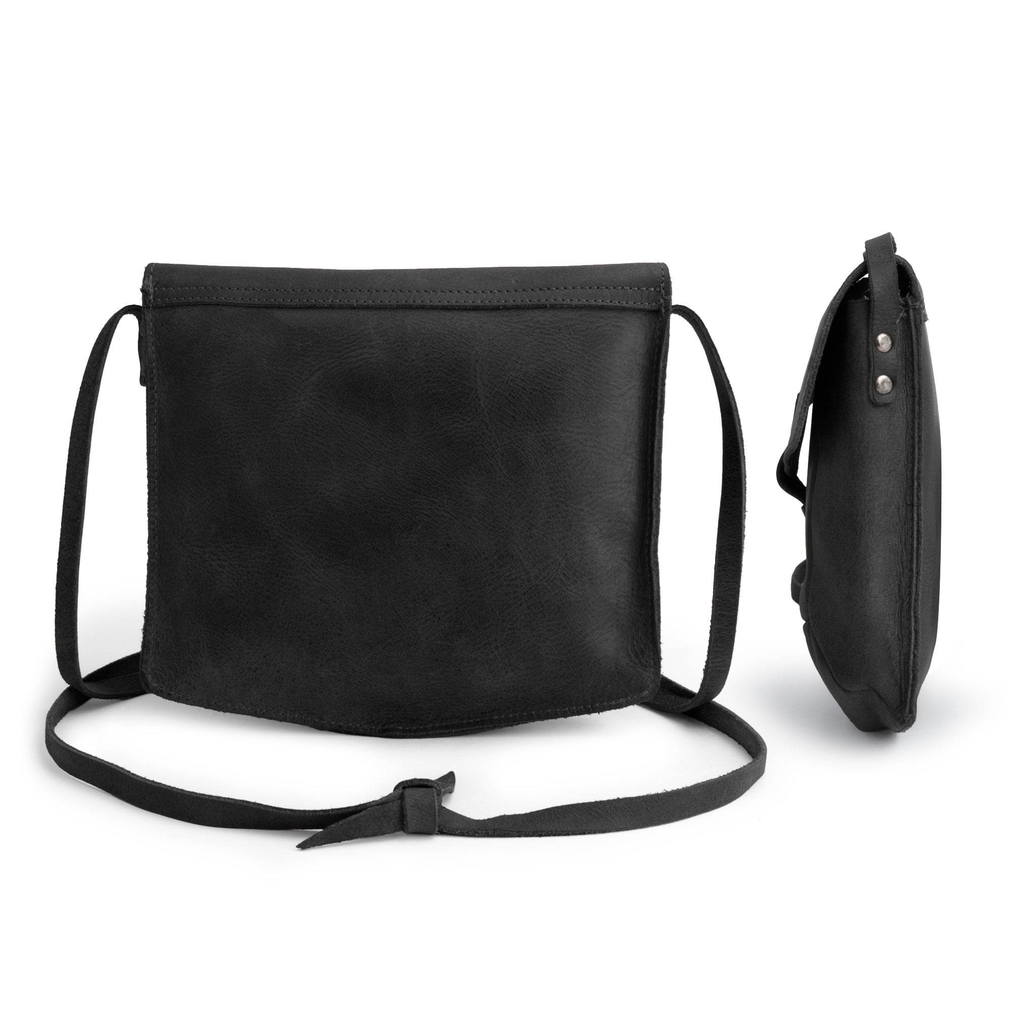 The interior of the black Prisma Shoulder Bag by Hide & Drink, demonstrating ample space. This vintage purse combines style and functionality as a messenger and crossbody bag, made from quality full grain leather and crafted by hand cut and hand sewn artisans in La Antigua Guatemala & Oaxaca Mexico.