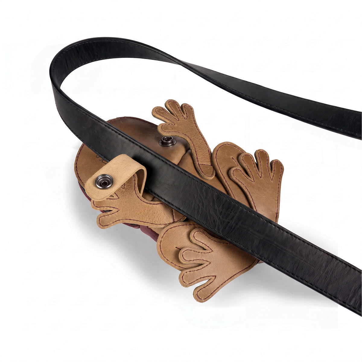Tudi Frudi Frog Pouch shown open beneath a black shoulder strap, highlighting its Frog-Shaped Pouch design, Full Grain Leather construction, and use as a Cable Organizer, Small Accessory Case, Zippered Cash Holder Wallet for Coins, and Change Purse. Ideal as Pouches for Men and Women, this StockyardX piece features Small Batch Production, Hand Cut, Hand Sewn, Fire Branded, Artisan craftsmanship, Handmade in La Antigua Guatemala & Oaxaca Mexico.