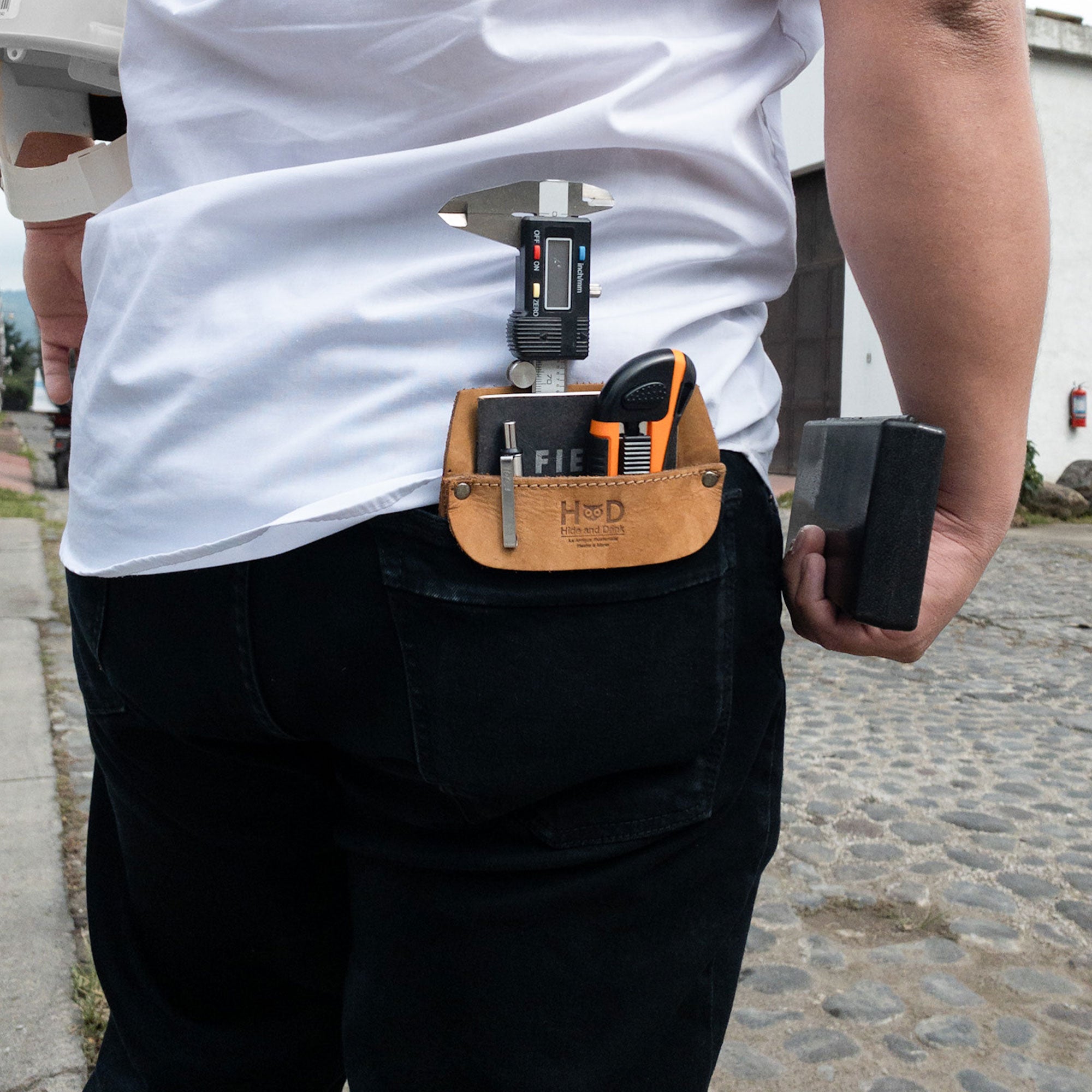 Hide & Drink Leather Work Pocket displayed in an outdoor setting, showcasing its versatility. This artisan-crafted Leather Work Pocket ensures you stay organized while on the go.