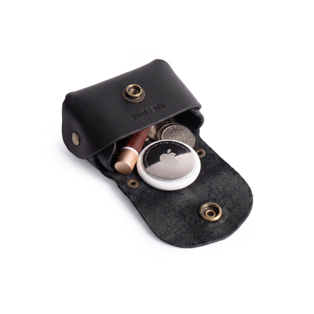 Interior view of the black Tiny Handbag Keychain by Hide & Drink, displaying keys and coins. Crafted from Full Grain Leather, this artisanal product represents small batch production and showcases excellent hand cut and hand sewn craftsmanship.