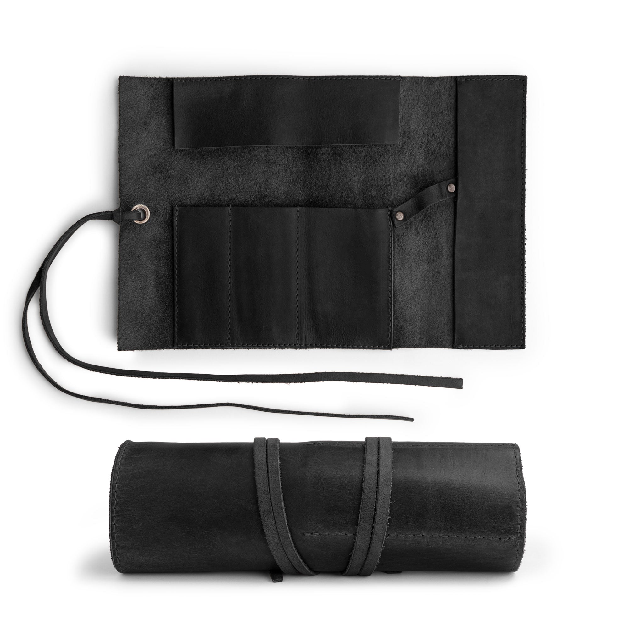 An open view of the Multi Purpose Pencil Roll by Hide & Drink highlights its elegant design, made from full grain leather. This versatile pencil roll pouch is ideal for organizing craft supplies, scissors, and earphones, hand sewn in small batches by skilled artisans in La Antigua Guatemala & Oaxaca Mexico.