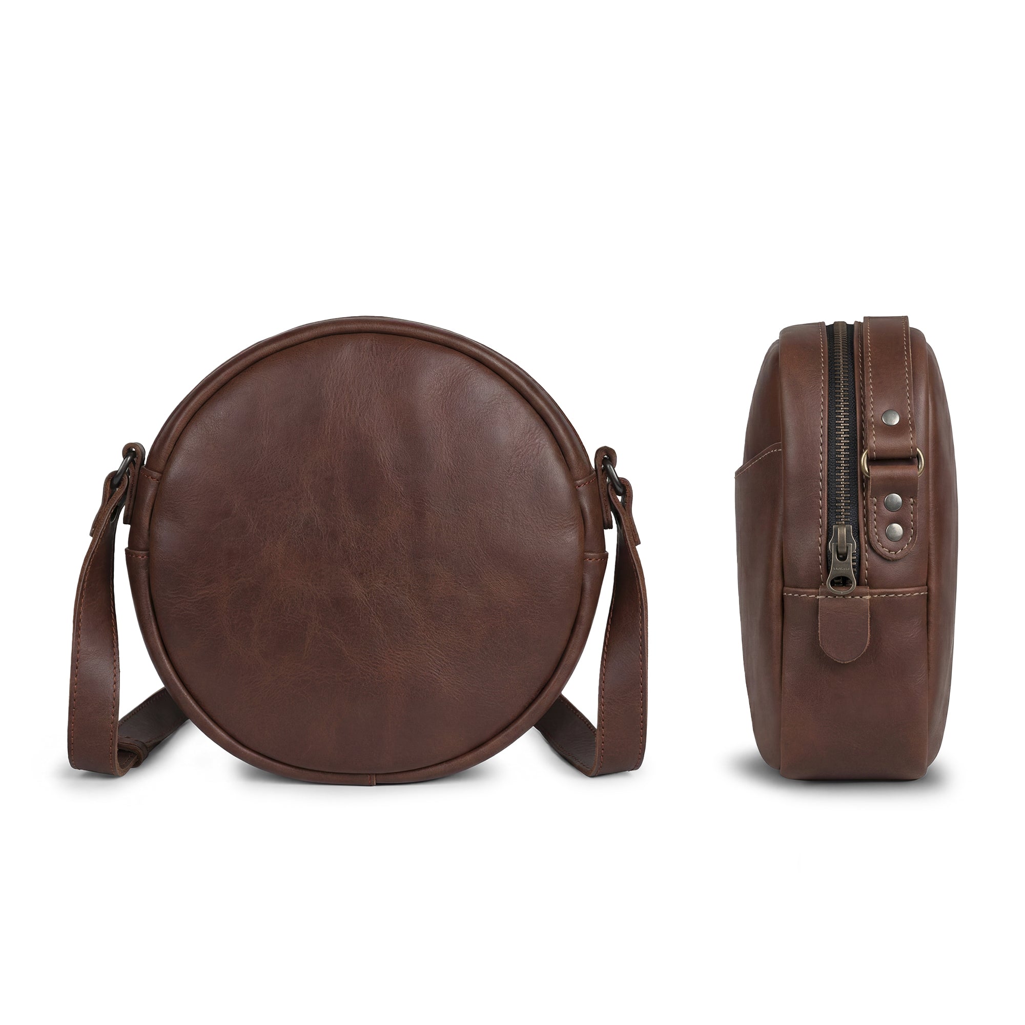 Back view of Heather's Female Rounded Crossbody Hand Bag highlighting its Full Grain Leather construction. This shoulder bag for girls is perfect for daily use, serving as a stylish zippered handbag for women. Handmade in La Antigua Guatemala, it features artisan craftsmanship with hand cut and hand sewn quality attributed to small batch production.