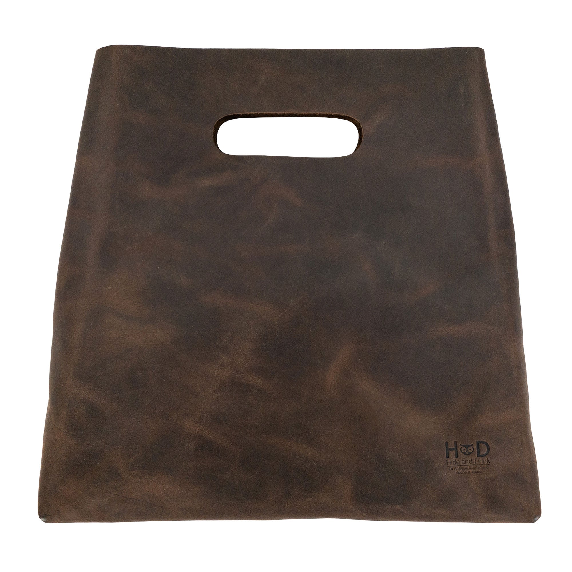 A close-up view of the brown Minimalist Boho Handbag by Hide & Drink, emphasizing its unique texture. This Minimalist Handbag for Women serves as a chic Tote Bag or Rustic Purse, crafted utilizing high-quality Full Grain Leather, underscoring StockyardX's dedication to artisan craftsmanship through Hand Cut and Hand Sewn methods, handmade in La Antigua Guatemala & Oaxaca Mexico.