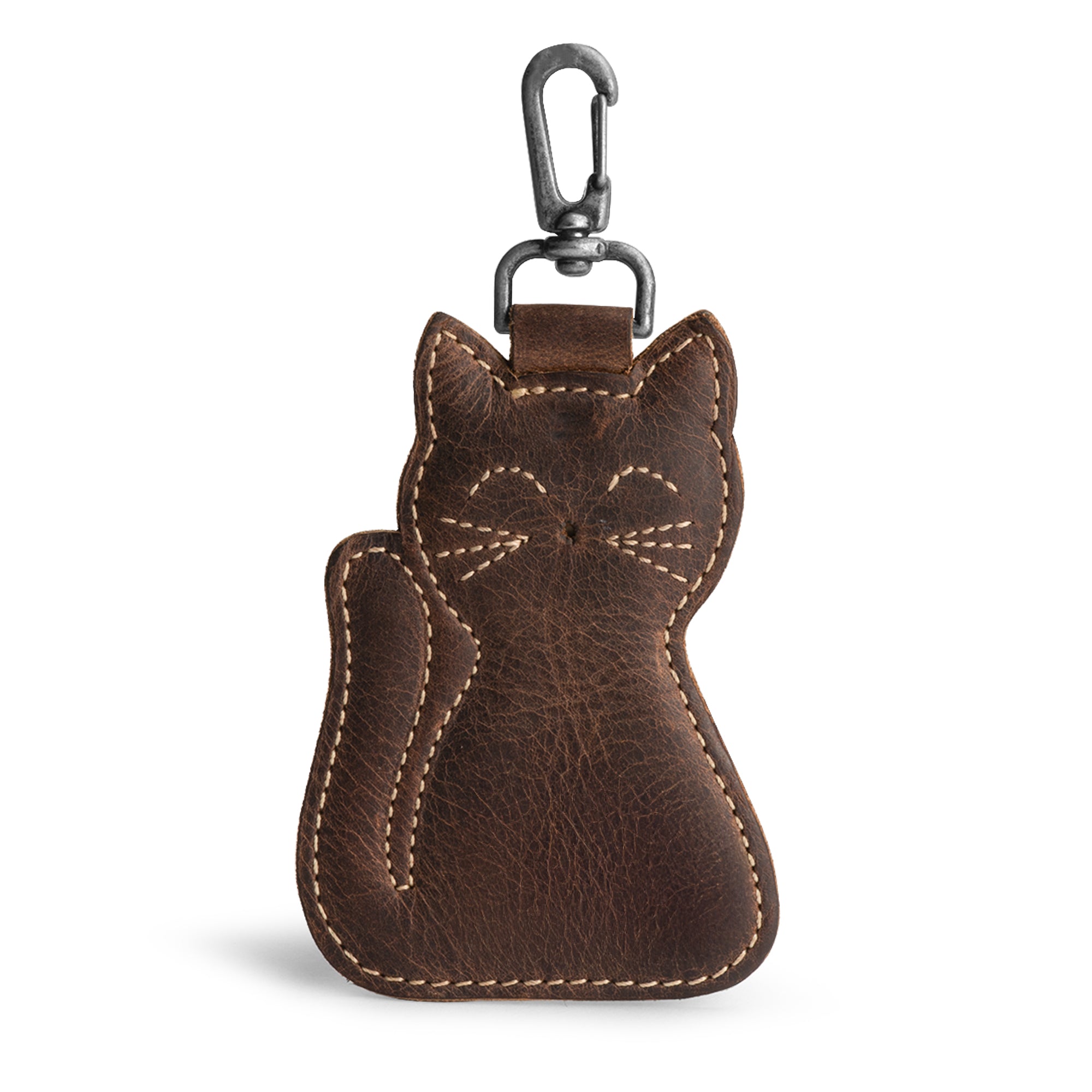 A stylish Cat Keychain by Hide & Drink, showcasing a charming cat-shaped design. This Cat-Shaped Keychain serves as a functional key organizer and a delightful stuffed animal-shaped ornament, crafted from high-quality Full Grain Leather. Handmade in La Antigua Guatemala and Oaxaca, Mexico, it features meticulous small batch production with hand cut and hand sewn details, and a fire-branded logo that highlights its artisan quality.