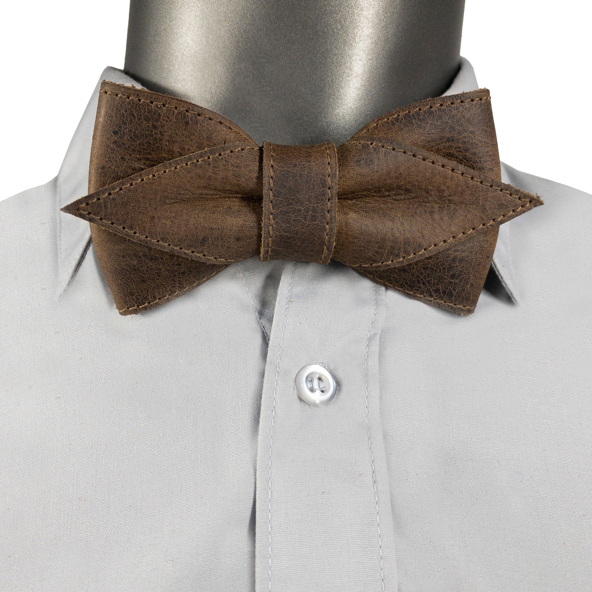 Model wearing the Pointed Bow Tie for Groomsmen by Hide & Groom, made from durable full grain leather. This pre-tied adjustable bow tie adds sophistication to any formal wear for men, reflecting the artisan quality of small batch production with hand-cut and hand-sewn details, fire branded for authenticity.