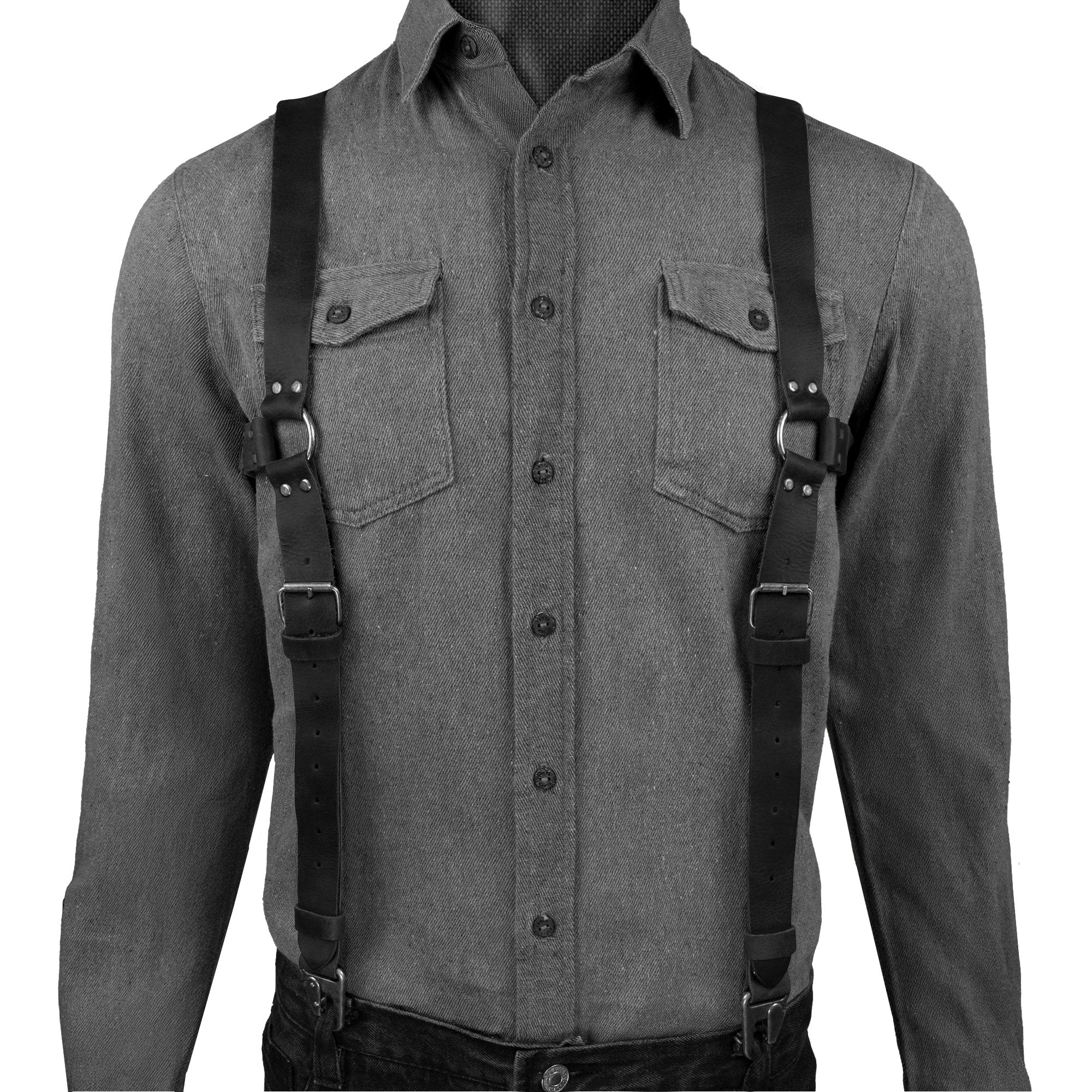 Model wearing black Renaissance Suspenders by Hide & Drink, illustrating their elegant fit. These suspenders function as back support harness for men, made from durable full grain leather, perfect for groomsmen.