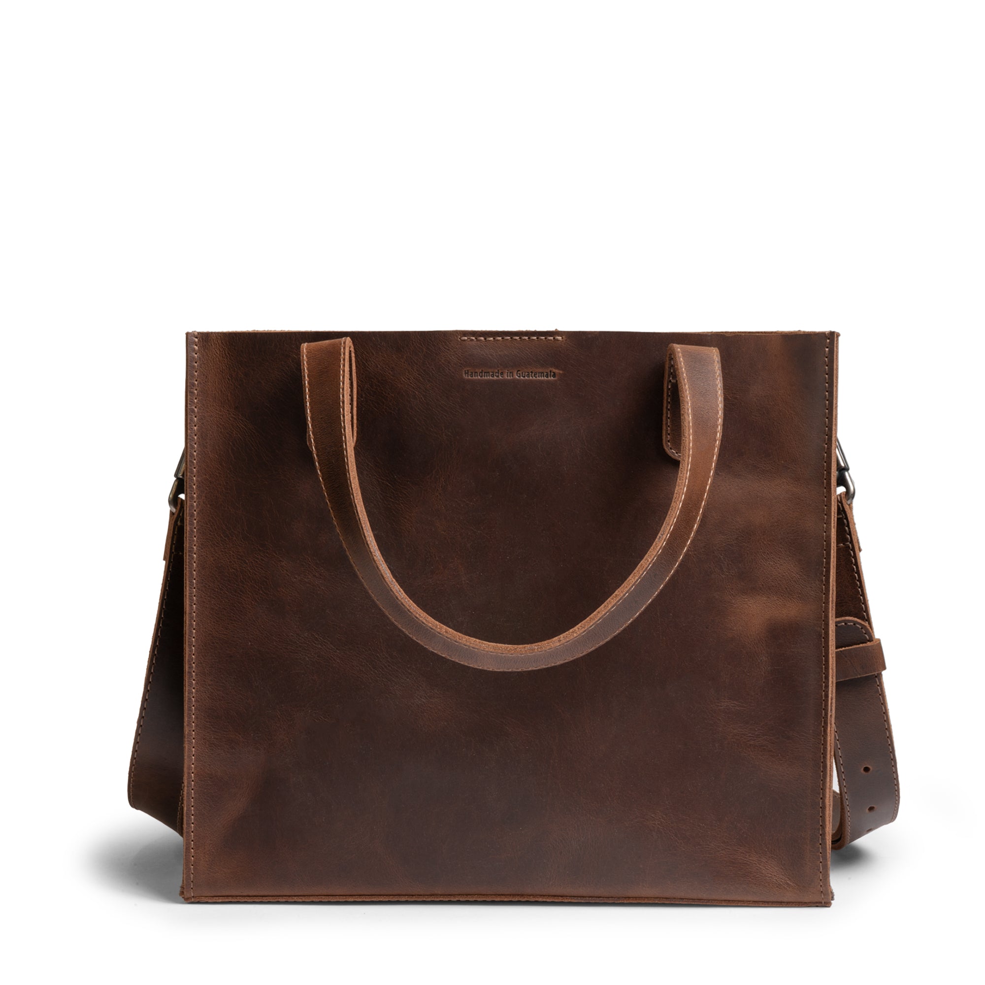 The Springdale Crossbody Tote, a stylish bag by Austin Genuine, displaying its beautiful full grain leather construction. Hand cut and hand sewn, this artisan tote celebrates craftsmanship from La Antigua Guatemala & Oaxaca Mexico.
