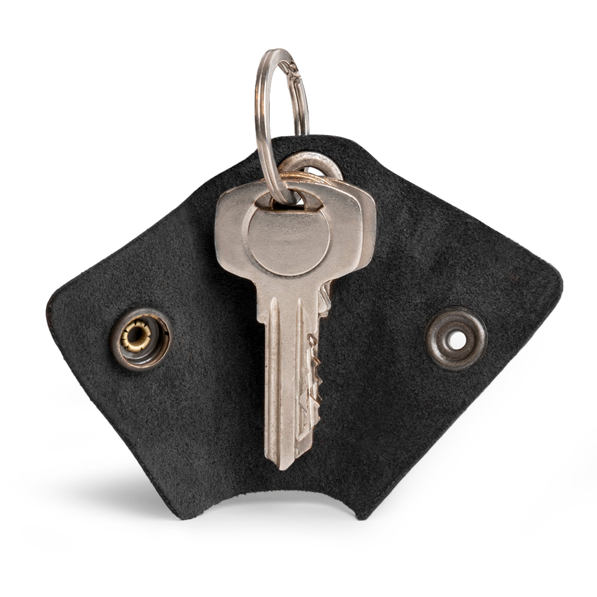 Functional Wrap Keychain by Hide & Drink, featuring an organizer snap closure for secure key management. This full grain leather key ring cover also acts as a silencer sleeve key holder for men. Handmade in La Antigua Guatemala, it embodies artisan craft with its hand cut and hand sewn design, highlighting the beauty of small batch production.