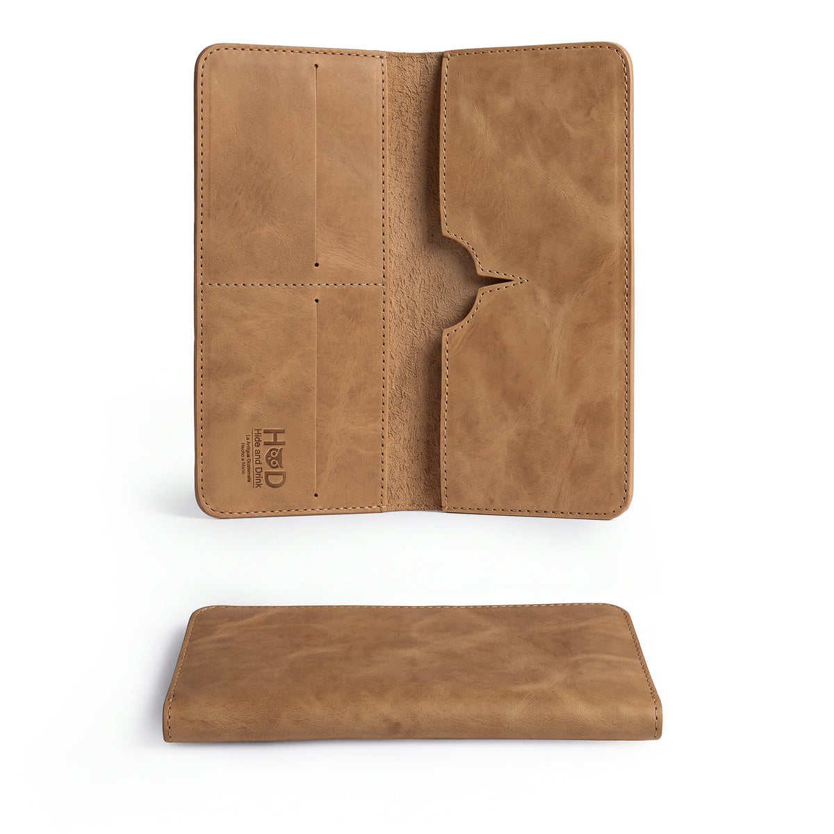Open rustic bifold wallet for cellphone by Hide & Drink, displaying card slots and cash compartments. This Bifold Wallet for Cellphone features high-quality Full Grain Leather, blending functionality and artisan design. Experience small batch production craftsmanship from La Antigua Guatemala & Oaxaca Mexico.


