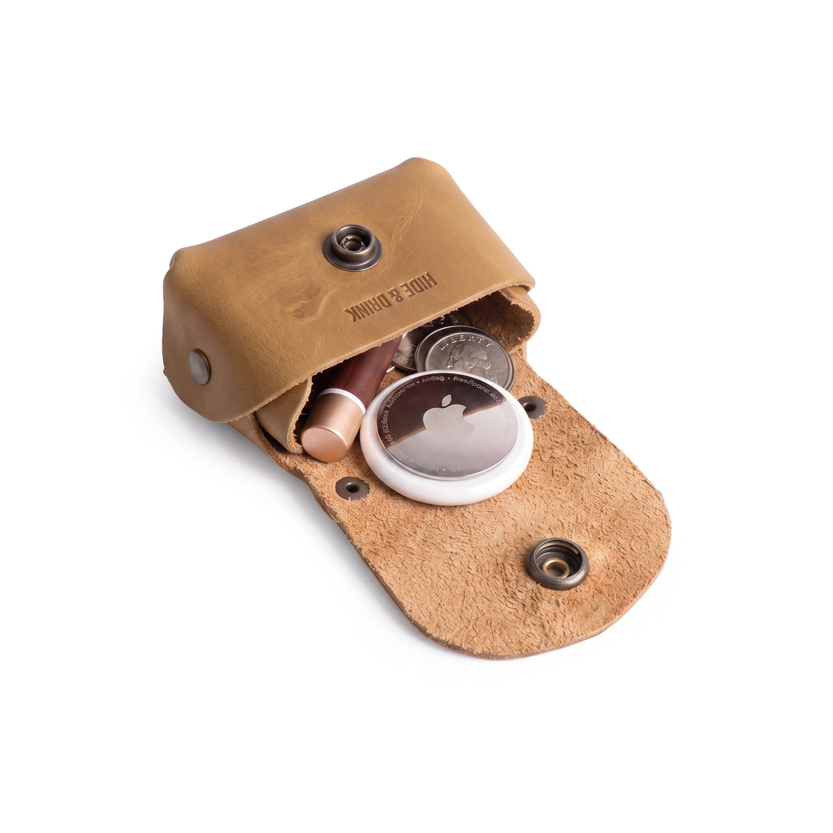 Front view of the Tiny Handbag Keychain in light brown leather, emphasizing its simplicity and key ring holder, made by Hide & Drink. This functional Tiny Handbag with Key Ring Holder features full grain leather craftsmanship and represents small batch production with hand cut, hand sewn, and fire branded quality, handmade in La Antigua Guatemala & Oaxaca Mexico.