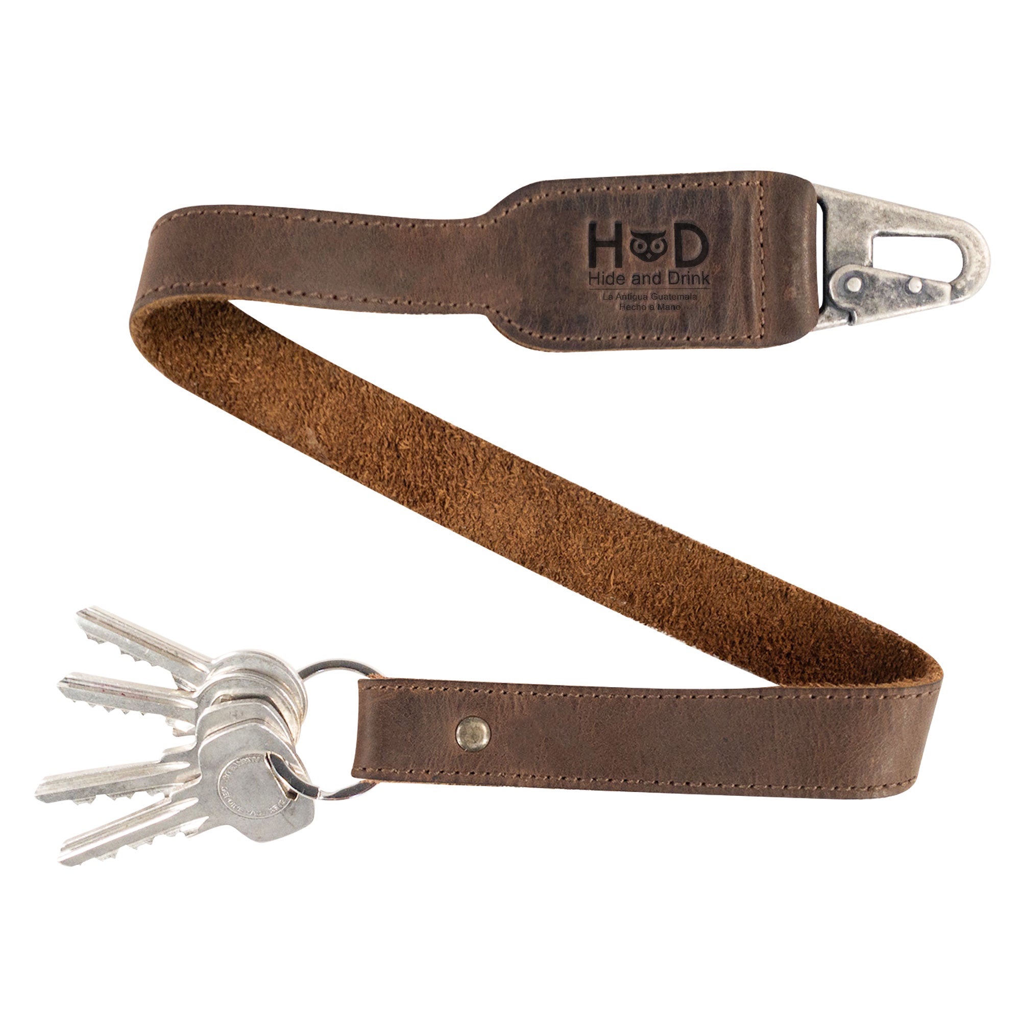 Hide & Drink Keychain Lanyard designed for convenience and style, made from Full Grain Leather. It includes a clip to easily attach to house, car, and apartment keys. This handmade item emphasizes small batch production, fire branded details, and artisan craftsmanship from La Antigua Guatemala.