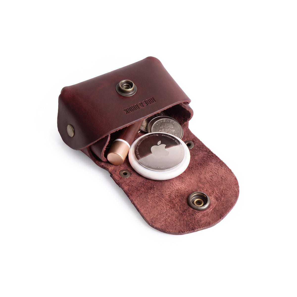 Inside view of the Tiny Handbag Keychain by Hide & Drink, filled with coins and keys, demonstrating the functional layout. This unique keychain in Full Grain Leather represents artisan quality through small batch production and meticulous hand cut and hand sewn techniques.