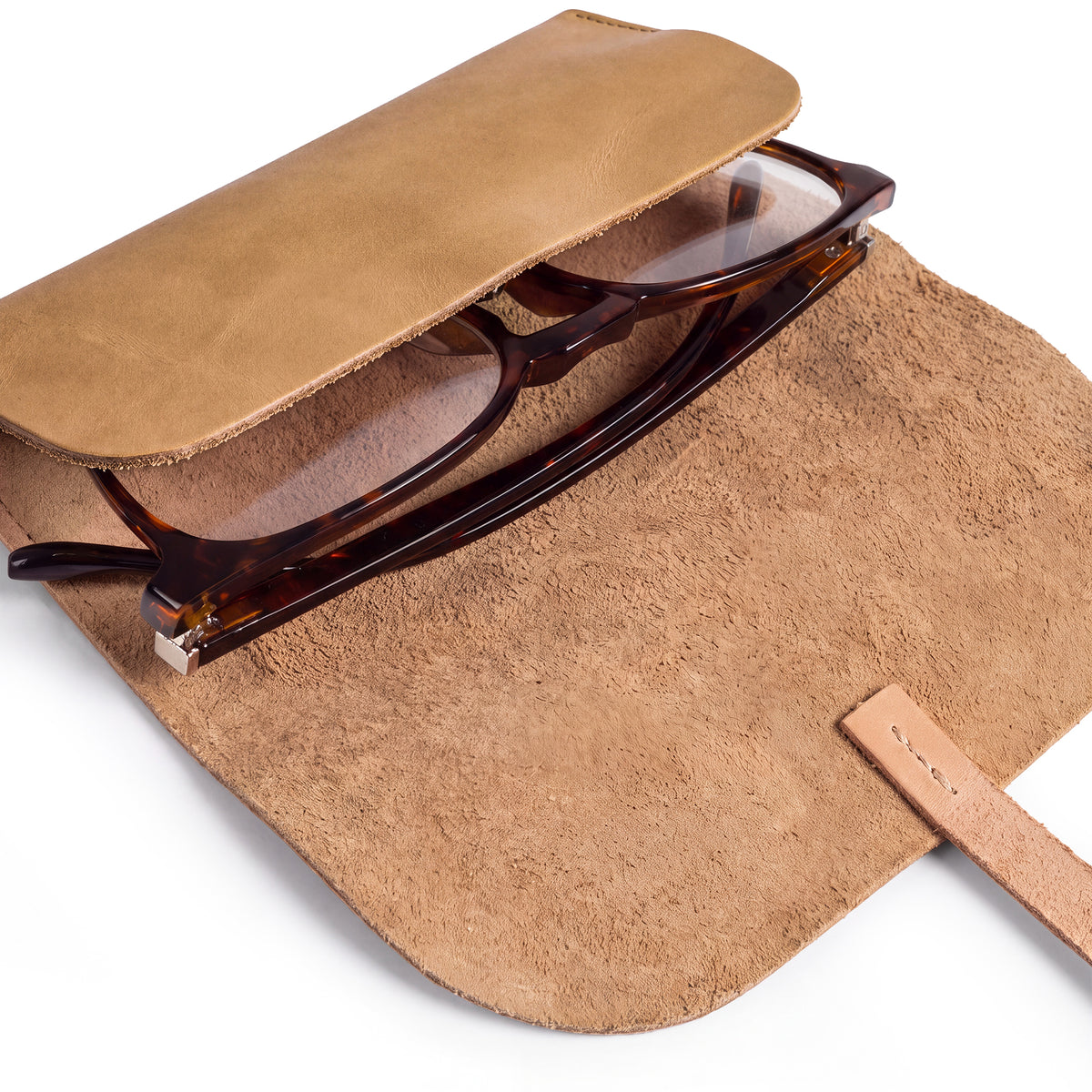 Hide & Drink Sunglass Wrap is elegantly designed to secure your eyewear. This eye glasses storage solution is handmade from full grain leather, making it perfect for travel. Artisan crafted and hand sewn in La Antigua Guatemala, it reflects quality and care.