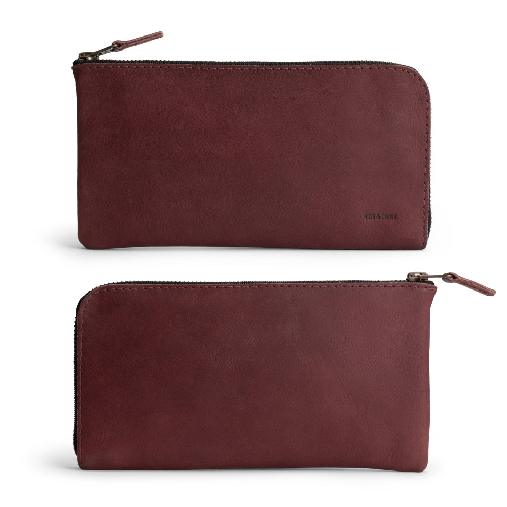 Front view of the Large Zippered Wallet by Hide & Drink in Sangria, perfect for showcasing its quality. This Long Zippered Wallet for Men and Women is not just a Card Holder, but also a Card Organizer and Bill Holder, making it an essential Travel Accessory. Made from Full Grain Leather in La Antigua Guatemala & Oaxaca Mexico, reflecting artisan craftsmanship.