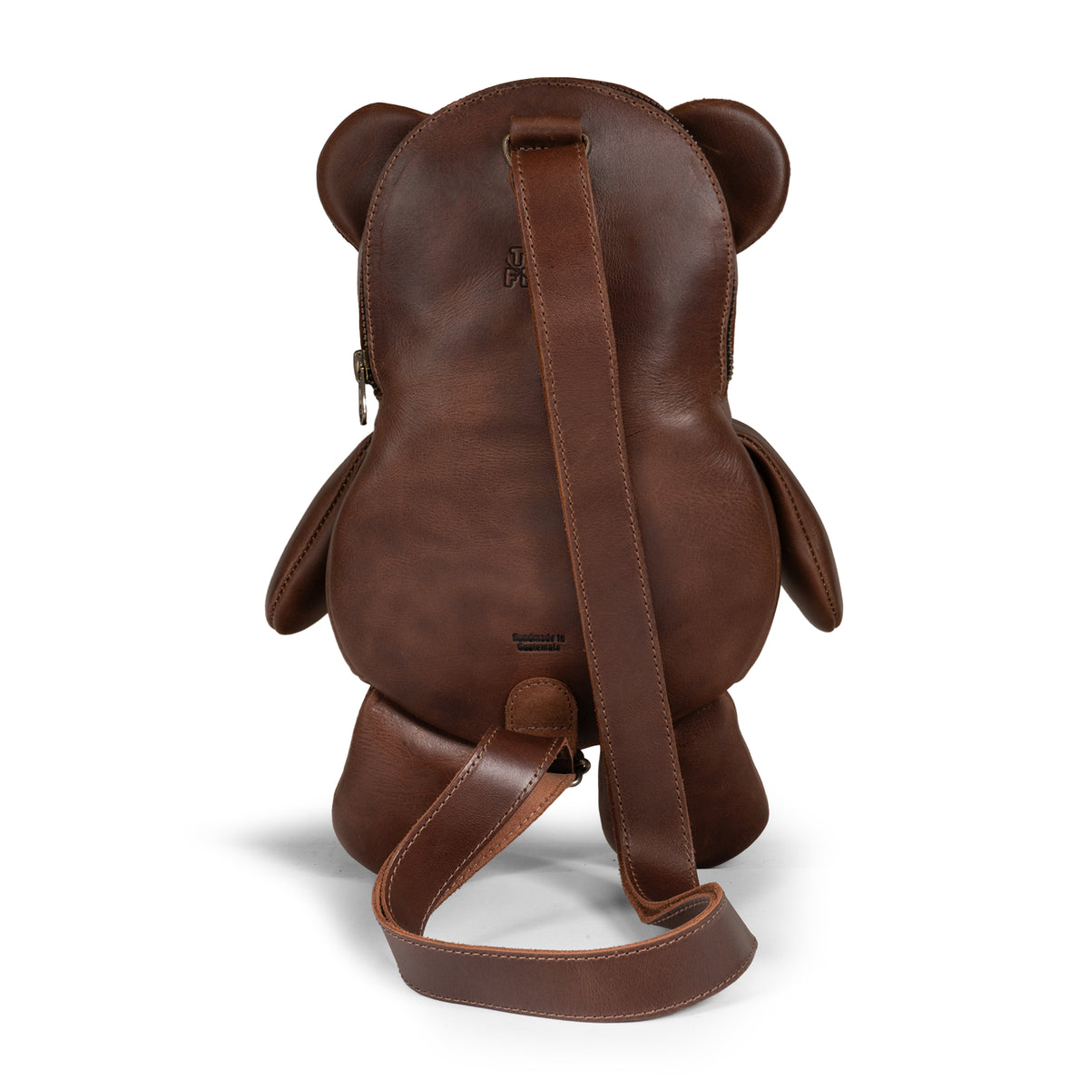 Back view of the Tudi Frudi Leather Teddy Bear Crossbody Bag with its long Adjustable Shoulder Strap and teddy bear backpack shape, designed as a Messenger Bag, Shoulder Bag, Zippered Sling Bags, Travel Backpack, Purses for Men and Women, and Satchel in Full Grain Leather by StockyardX, made through Small Batch Production, Hand Cut, Hand Sewn, Fire Branded, Artisan, Handmade in La Antigua Guatemala & Oaxaca Mexico.