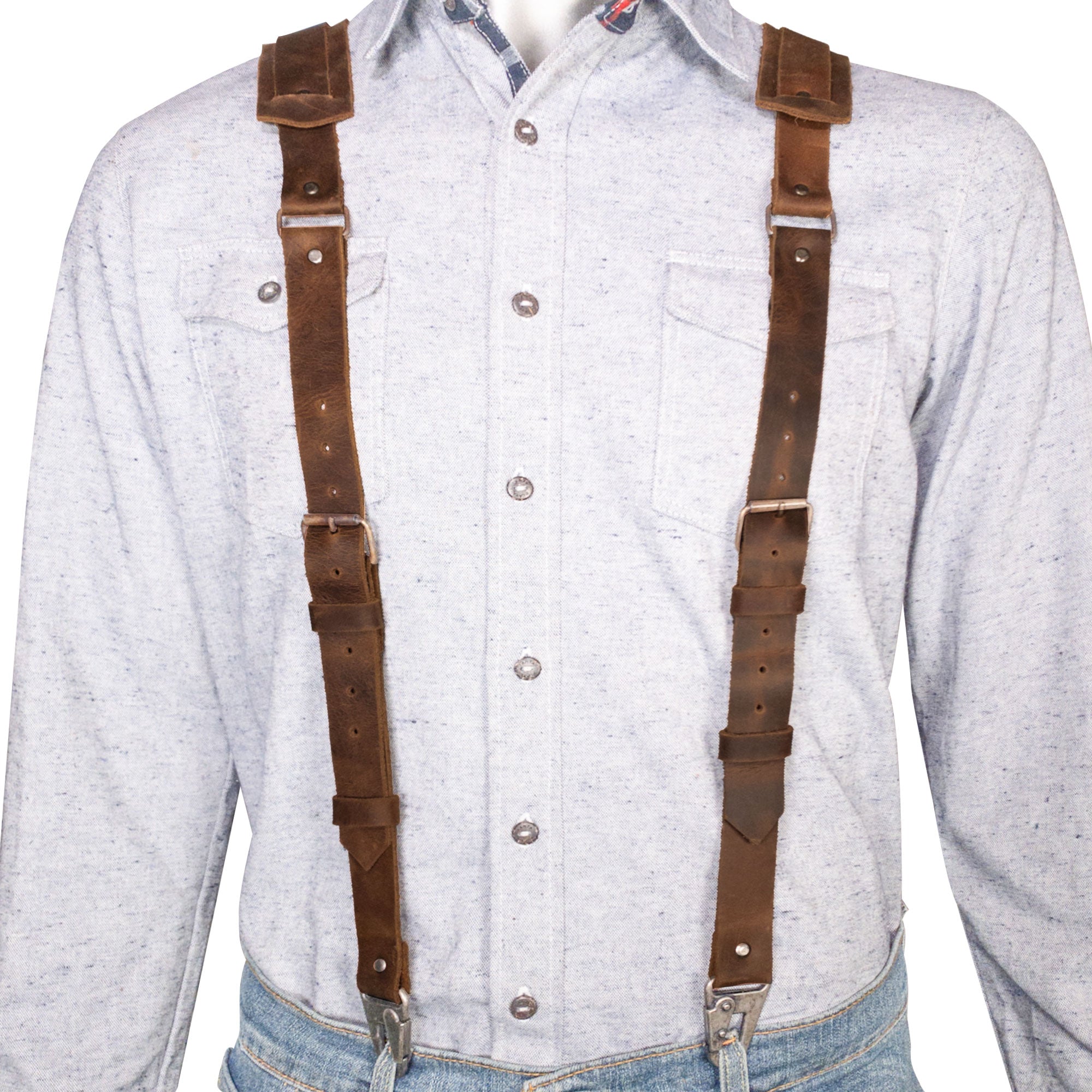 A model showcases the Hipster Suspender with Adjustable Straps by Hide & Groom, emphasizing the Full Grain Leather material. These Hipster Style Suspenders with Adjustable Straps are made through Small Batch Production, featuring Hand Cut, Hand Sewn, and Fire Branded details, embodying artisan quality that is handmade in La Antigua Guatemala & Oaxaca Mexico.