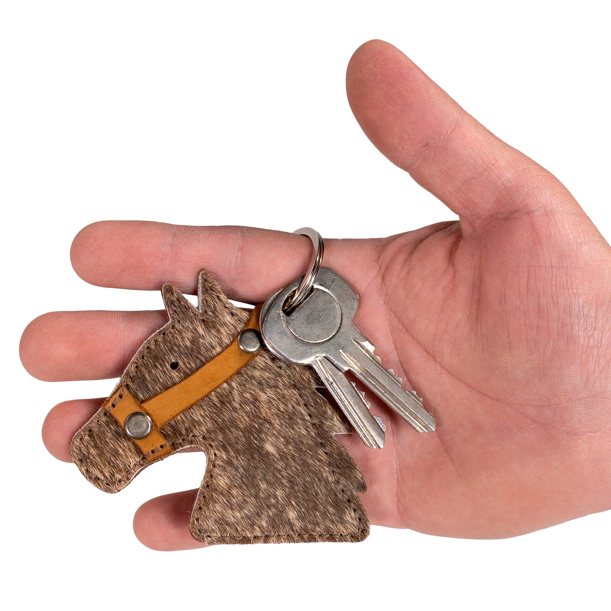 Cowboy Stallion Head Keychain by Western Leather Works held in hand, demonstrating its practical size and rustic beauty. This small batch artisan creation is made from Full Grain Leather in La Antigua Guatemala & Oaxaca Mexico, hand cut and sewn for quality that lasts.