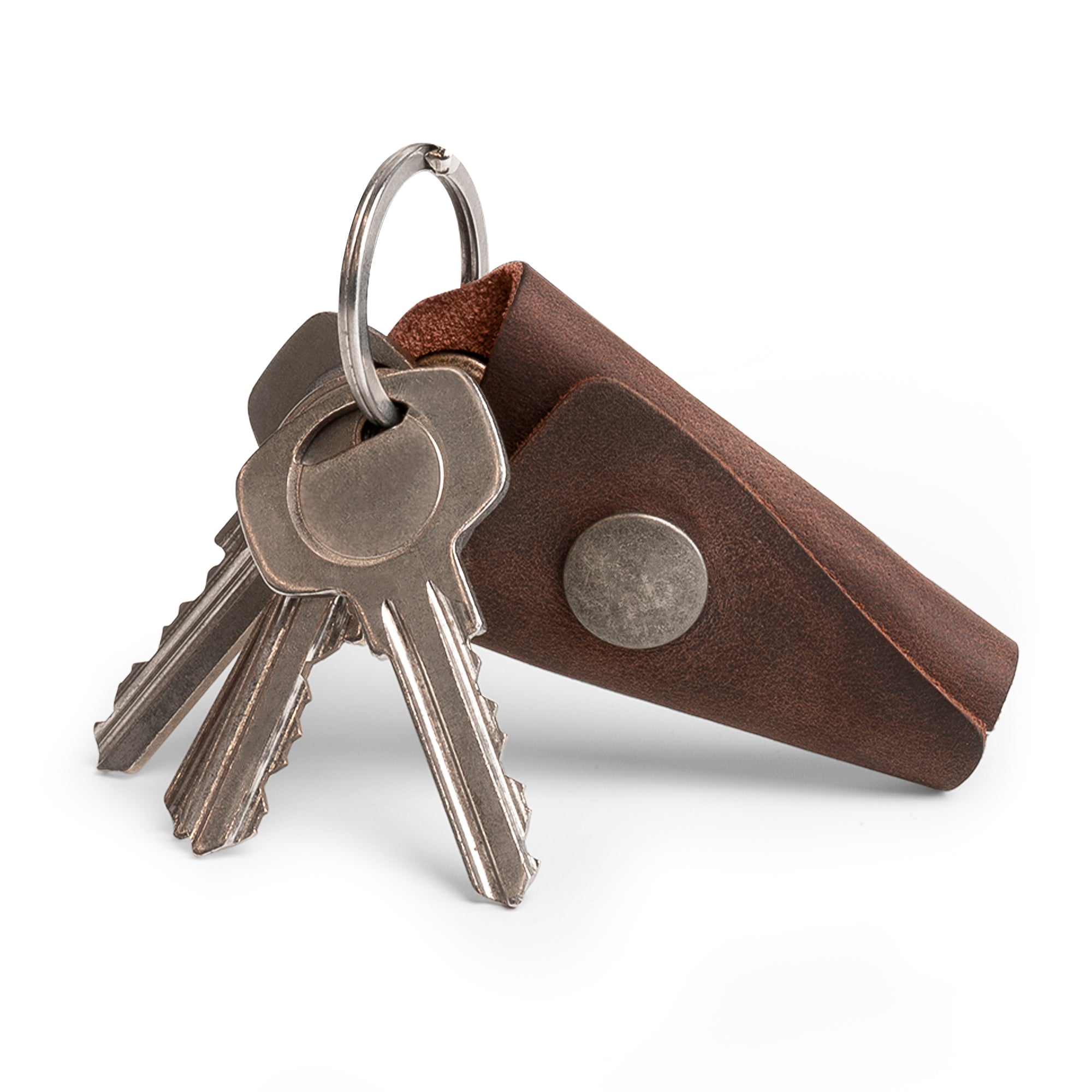 Versatile Wrap Keychain by Hide & Drink, showcasing a chic design in full grain leather. With an organizer snap closure, it functions as a practical key ring cover and silencer sleeve key holder for men. Handmade in La Antigua Guatemala using small batch production, this item reflects fine artisan craftsmanship through its hand cut and hand sewn construction.