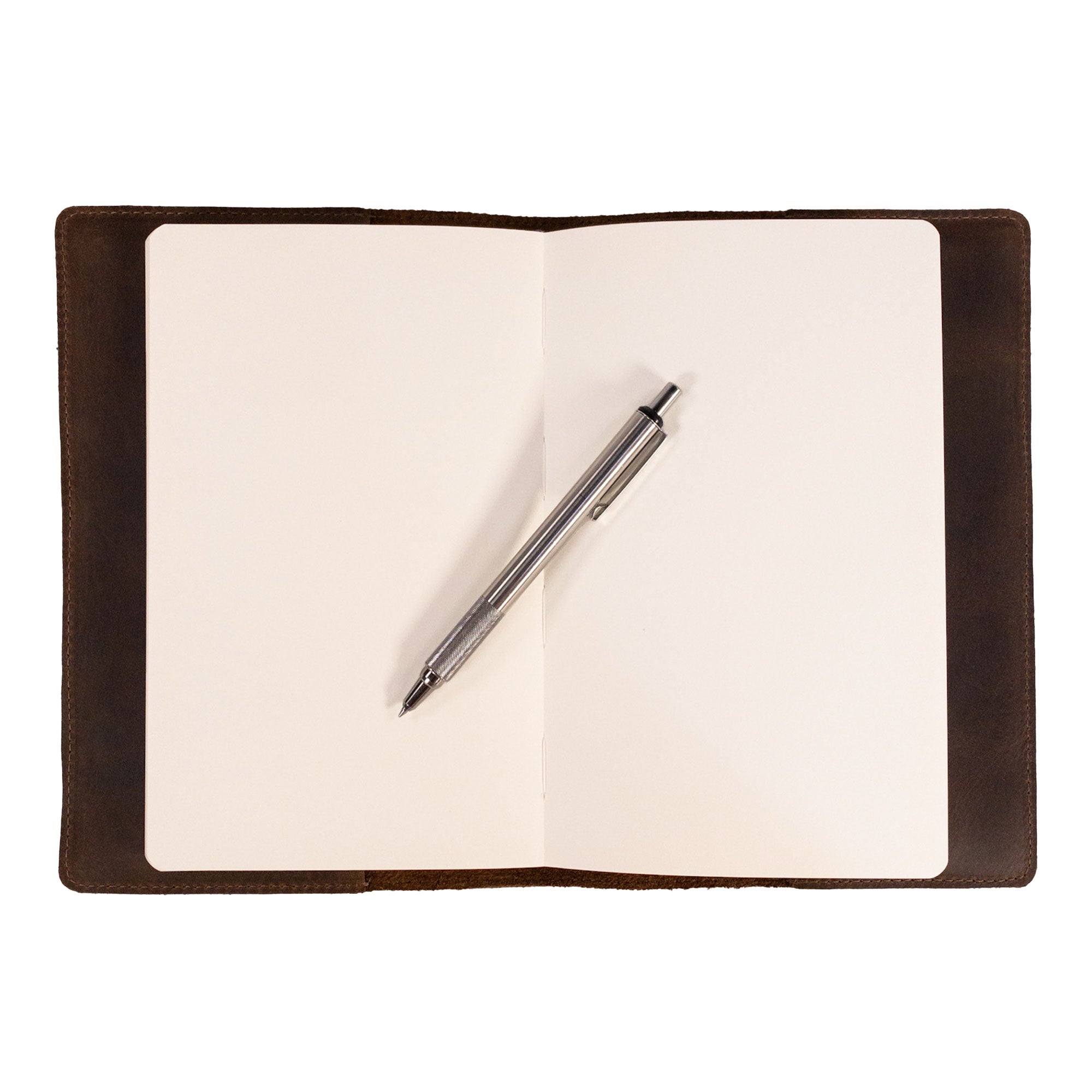 Open view of the Rustic Journal Cover for Hardcover A5 Notebook by La Antigua, featuring a blank interior ready for creativity. The protective cover designed for the Hardcover Leuchtturm A5 (5.75 x 8.25 in.) Notebook is perfect for writing and sketching, made with durable full grain leather through artisan craftsmanship in La Antigua Guatemala. A thoughtful and stylish writing accessory for personal planners.