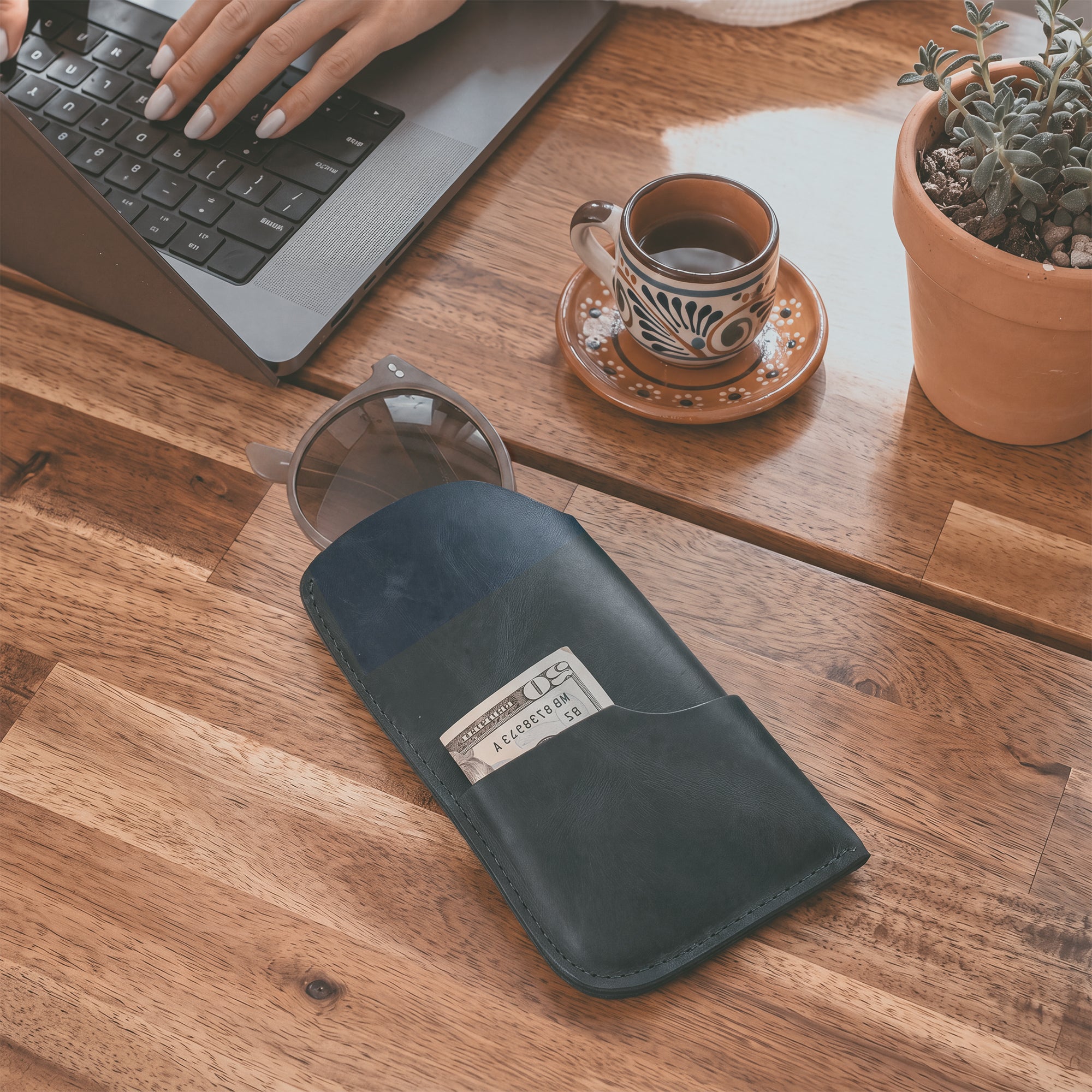 The Hide & Drink Sunglass Case & Wallet depicted in its practical use. This Rustic Sunglasses Case & Wallet, made from premium Full Grain Leather, serves as an essential eyeglasses sleeve for travel, expertly crafted in La Antigua Guatemala & Oaxaca Mexico.
