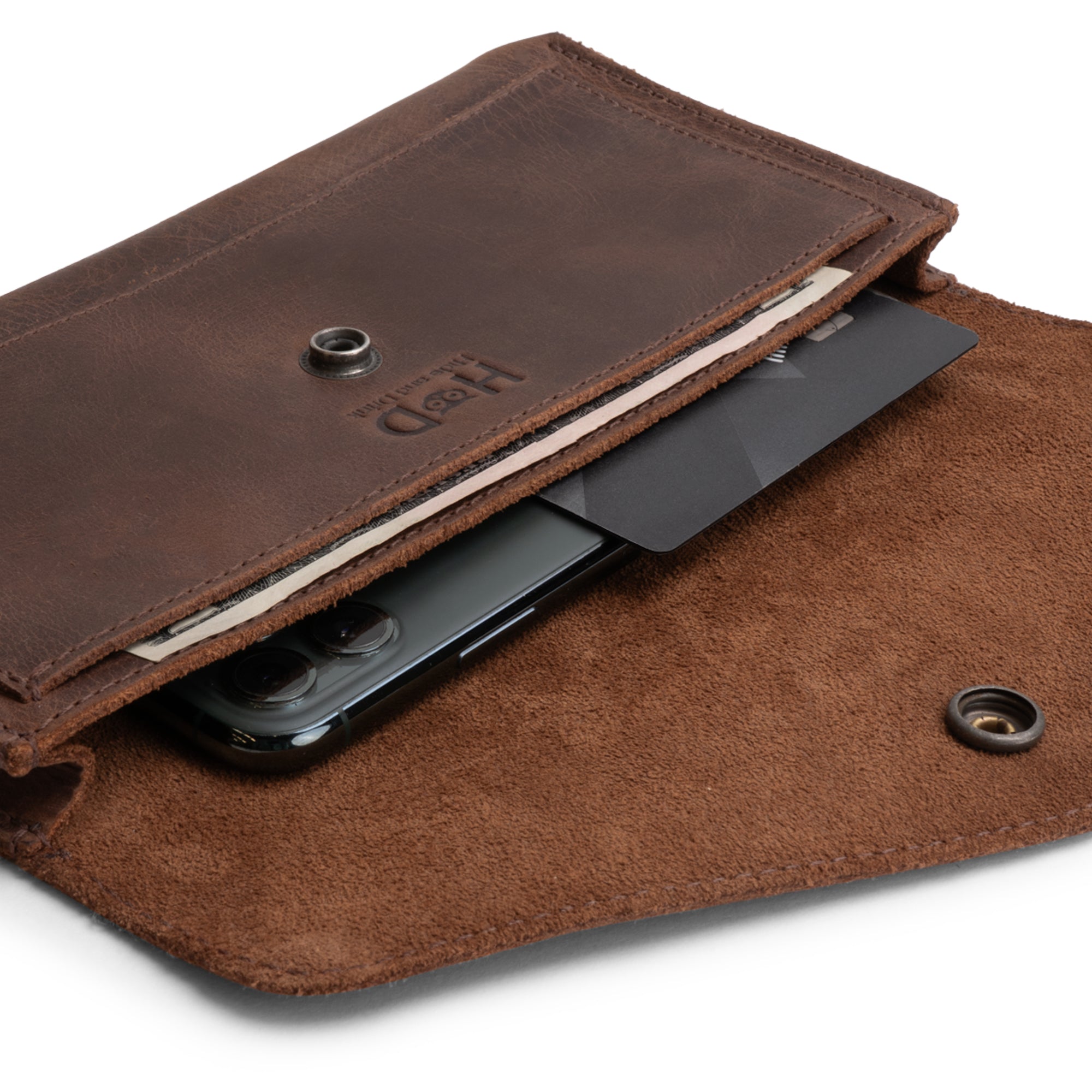 An interior shot of the Large Female Wallet by Hide & Drink, which shows how it accommodates cash, cards, and a phone comfortably. This Vintage Money and Card Holder is an essential Travel Organizer for Women, crafted from Full Grain Leather through Small Batch Production and artisan methods, all Handmade in La Antigua Guatemala & Oaxaca Mexico.