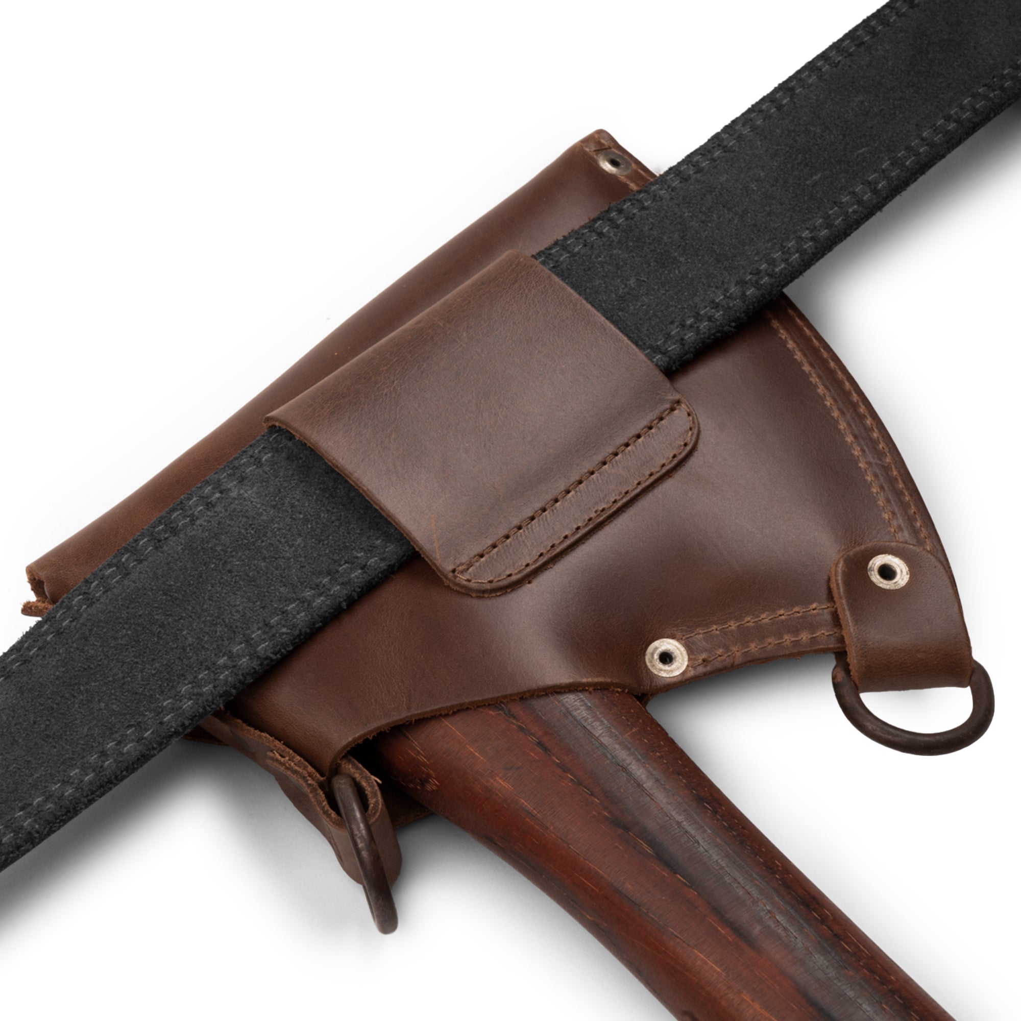 Close-up of the Axe Head Sheath with Shoulder Strap by Valhalla Gear, highlighting the solid rivets and craftsmanship of full grain leather. This artisan-made sheath features a convertible edge protector and is ideal for home improvement projects, promoting small batch production and fire branded quality.