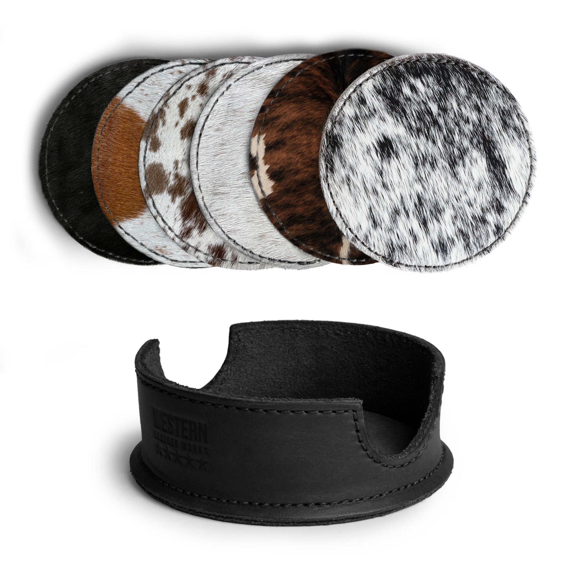 An assortment of hair-on-hide coasters presented with their storage holder from Western Leather Works, featured in the Set of 6 Circular Coasters for Drinks. These coasters are perfect for Glass & Cups Stain Protection, crafted from Full Grain Leather, reflecting the small batch production ethos and showcasing meticulous hand cut and hand sewn craftsmanship, with fire branding that denotes their artisan origin from La Antigua Guatemala & Oaxaca Mexico.