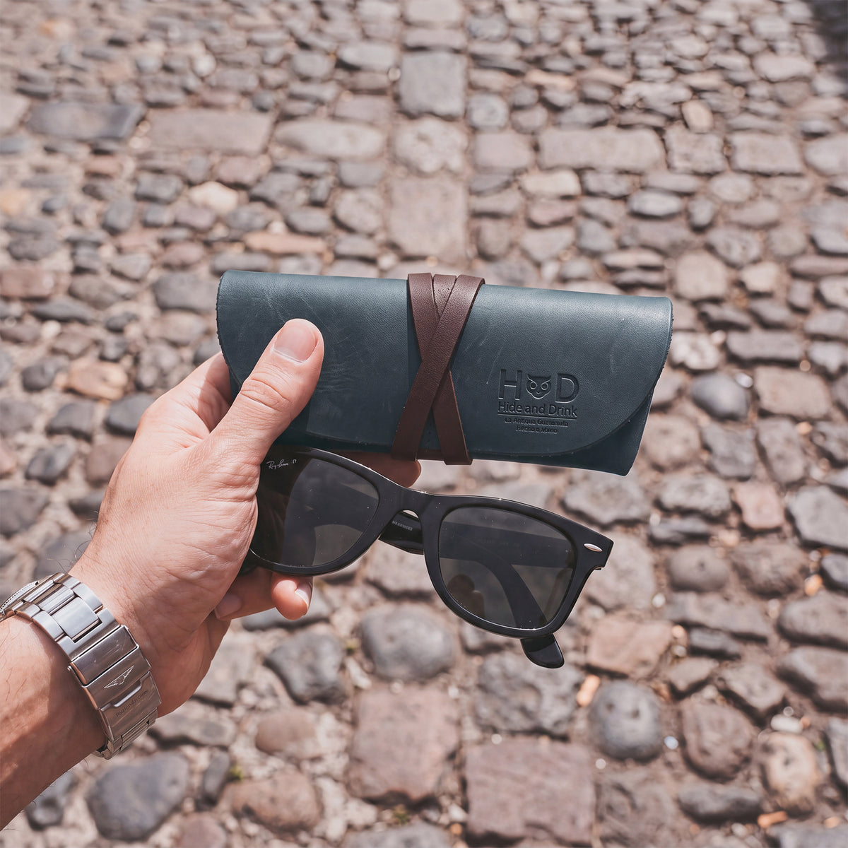 Hide & Drink Leather Sunglass Wrap offers a stylish, functional way to protect your sunglasses. This eye glasses storage is made from premium full grain leather, ideal for travel, and showcases artisan craftsmanship.