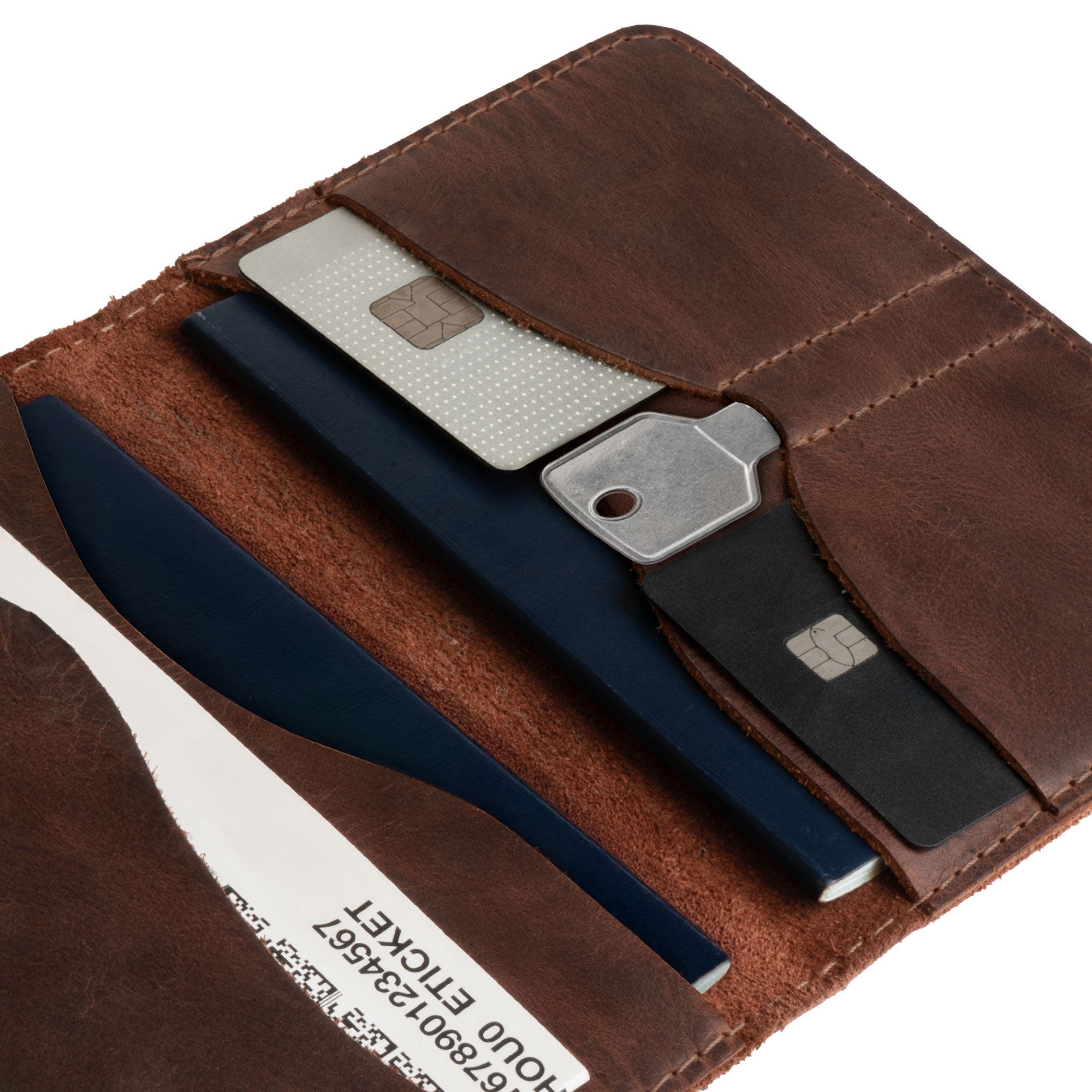 Close-up of the Hide & Drink Double Passport Wallet W/Key Slot, highlighting the hand-cut and hand-sewn craftsmanship of this rustic full grain leather wallet, perfect for organizing your travel essentials.