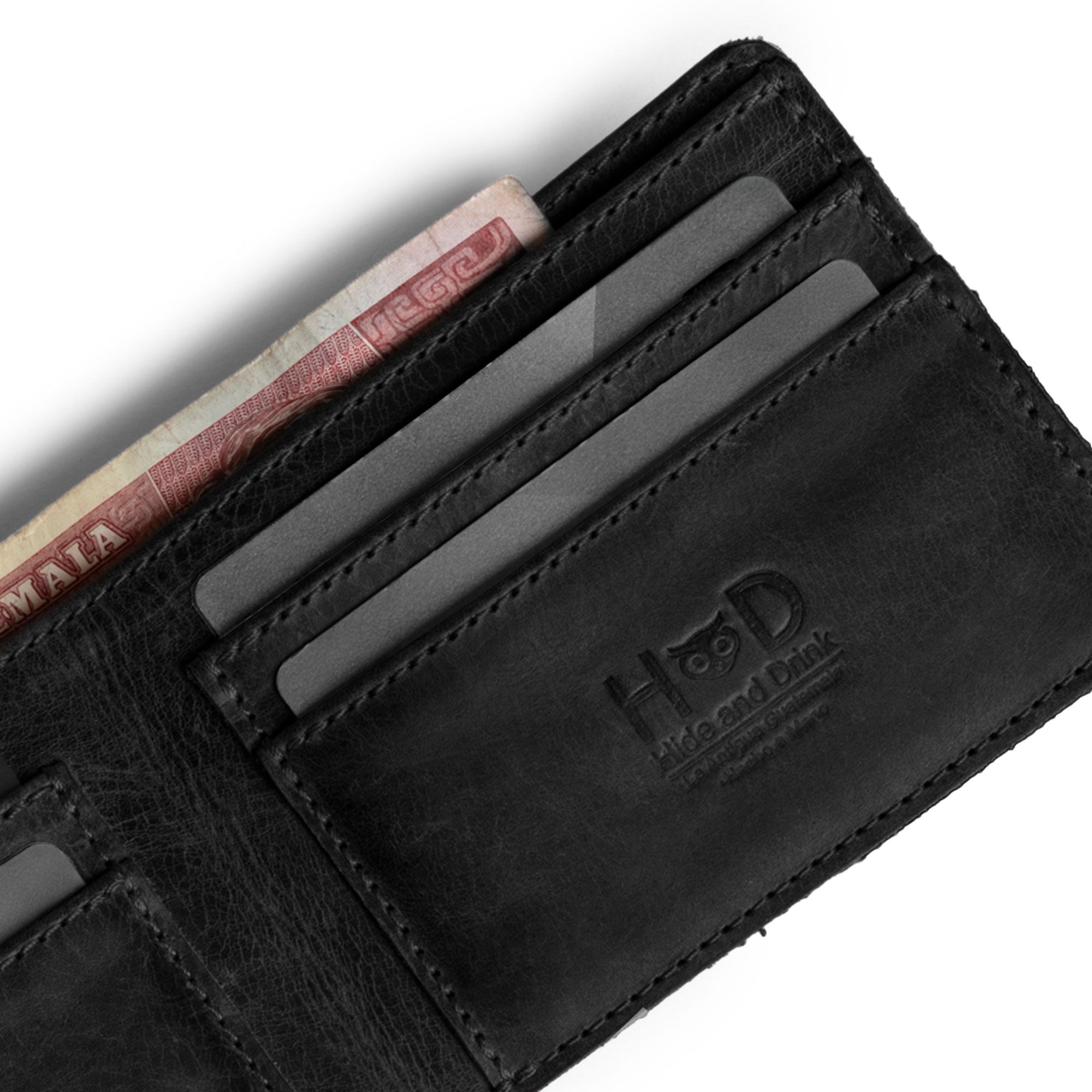 Open view of Hide & Drink's black Bifold Wallet displaying card slots and cash area. This Slim Bifold Wallet acts as a classic billfold for storing money, cash, and cards, making it an essential travel accessory crafted from durable full grain leather, handmade in La Antigua Guatemala & Oaxaca Mexico.