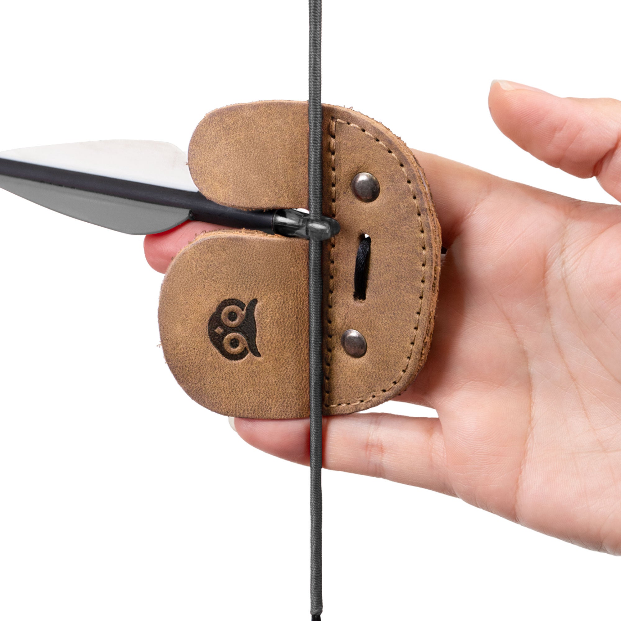 Hand model presenting the Right Handed Archery Finger Protector by Hide & Drink, highlighting its function as an Archery Finger Tab for protecting fingers while shooting. Crafted from Full Grain Leather, this durable Protect Guard is designed for shooting practice gear sports & outdoors enthusiasts. Each piece embodies Small Batch Production with a hand cut and sewn quality, fire branded for an artisan finish in La Antigua Guatemala & Oaxaca Mexico.